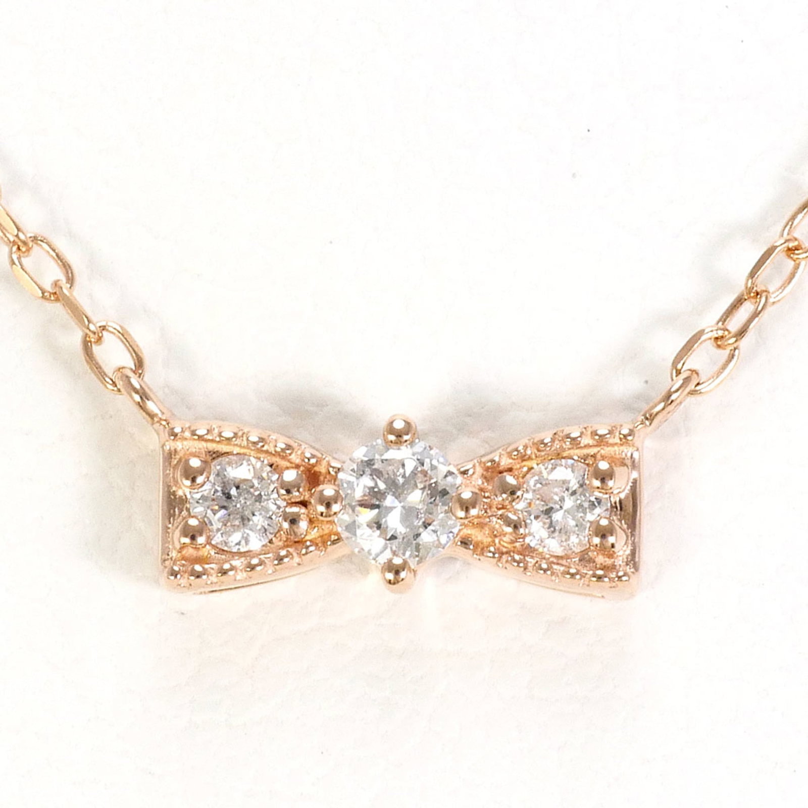 Pink Gold (10K): Pink Gold (10K) Pink gold 10K necklace with a 0.9g diamond pendant, featuring a 41cm chain circumference and a 3mm x 8mm pendant size. This necklace is in like new condition, with only the faintest tr