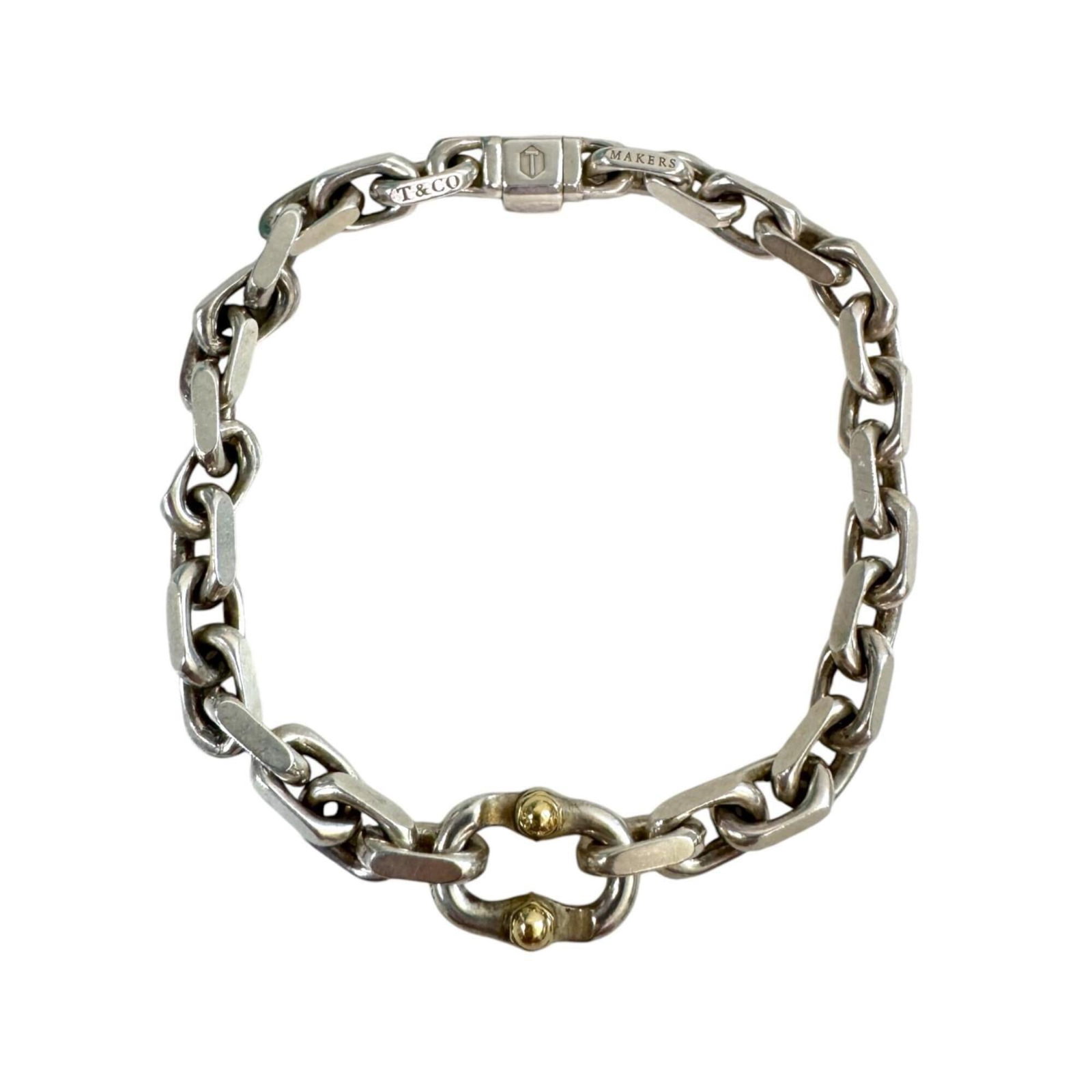 TIFFANY Charm Bracelet Sterling Silver 925 Yellow Gold (18K): TIFFANY Charm Bracelet Sterling Silver 925 Yellow Gold (18K) Sterling silver 925 and 18K yellow gold come together in this elegant Tiffany charm bracelet, offering a touch of sophistication to any out