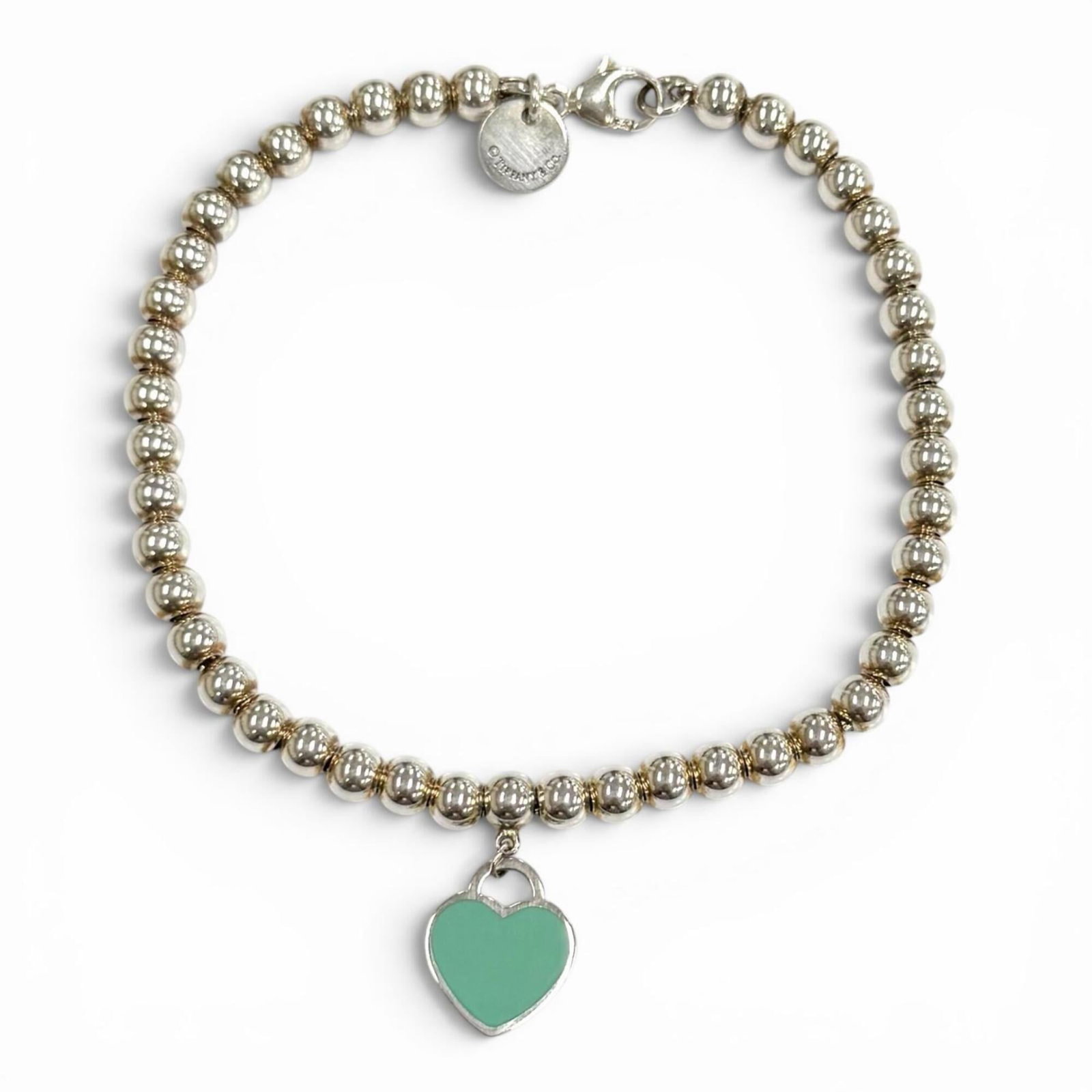 TIFFANY Charm Bracelet Silver 925: TIFFANY Charm Bracelet Silver 925 Silver 925 Charm Bracelet from Tiffany, featuring a blue and silver design, measures 17.5cm in length. This gently used charm bracelet has minor signs of wear, includ