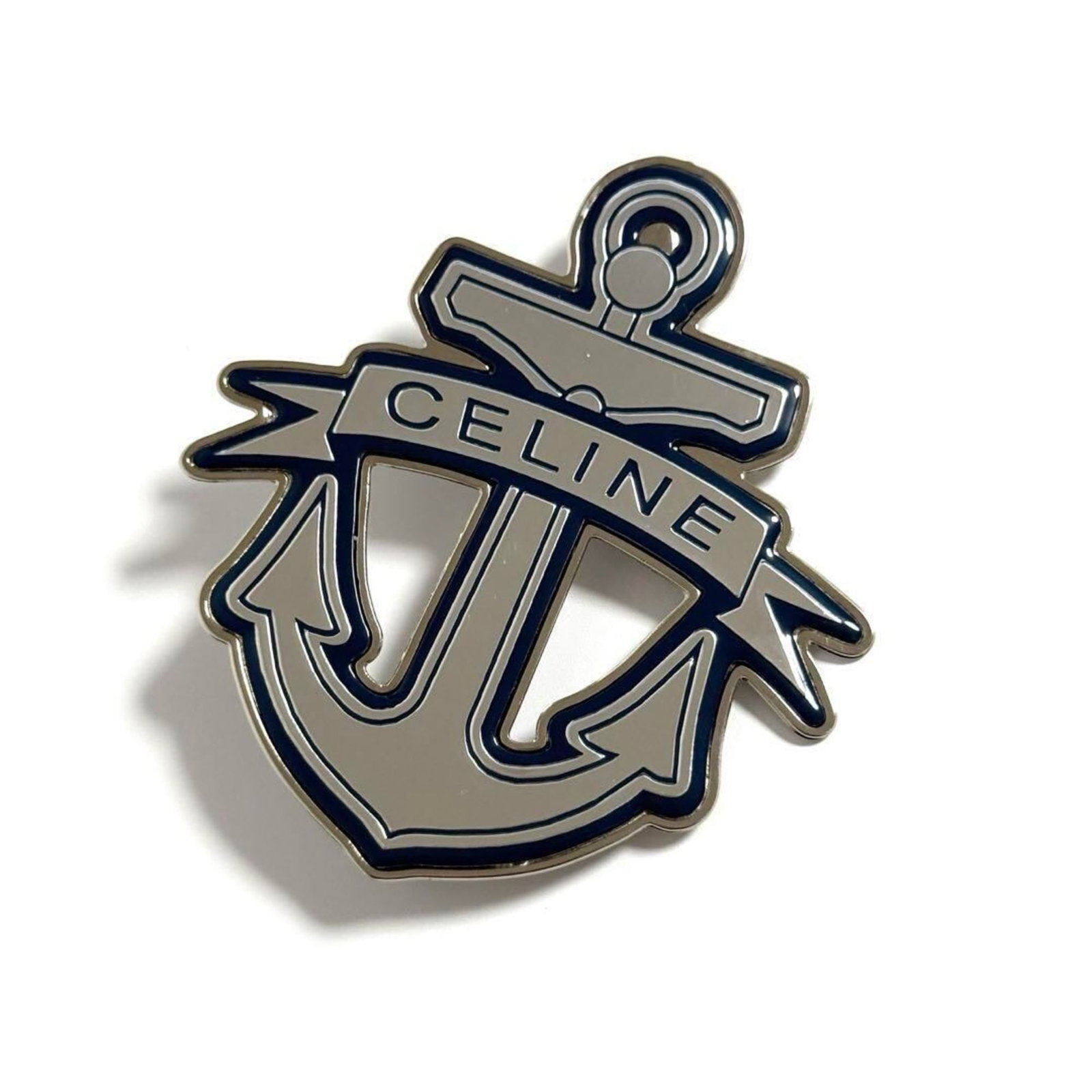 CELINE Brooch Metal: CELINE Brooch Metal The Celine Brooch Metal is a stunning piece featuring a striking blue and silver design. Made from metal, this brooch measures 8cm x 7cm and boasts a sleek, modern aesthetic. In