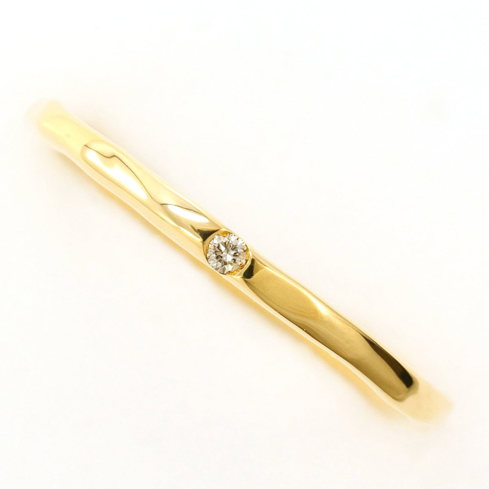 Band Ring Yellow Gold (18K): Band Ring Yellow Gold (18K) Yellow gold band ring with 0.01ct diamond, crafted from 18K gold, offering a subtle yet elegant look. This 5.5 US size ring features a 1.5mm wide band, weighing 1.3g, and i