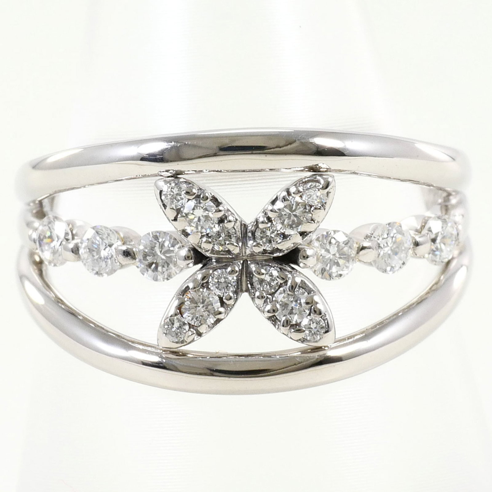 Band Ring White Gold (18K): Band Ring White Gold (18K) White gold band ring with a 0.40ct diamond, made from 18K metal, available in a US size 6.5 and 12mm width. This like-new band features a subtle, elegant design and weighs
