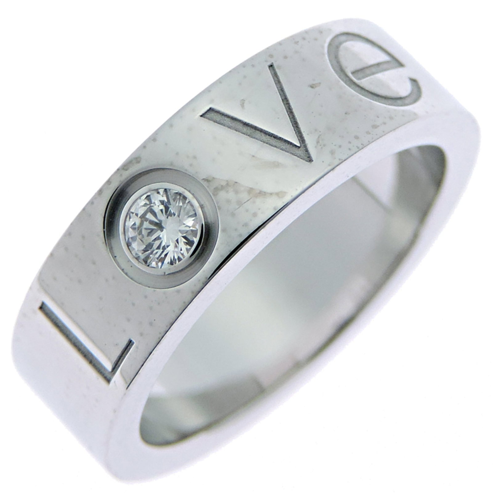 CARTIER Band Ring White Gold (18K): CARTIER Band Ring White Gold (18K) Cartier Band Ring White Gold (18K) is a pre-owned 18K white gold band ring featuring a diamond stone. The ring bears visible wear, including scratches and scuffs,