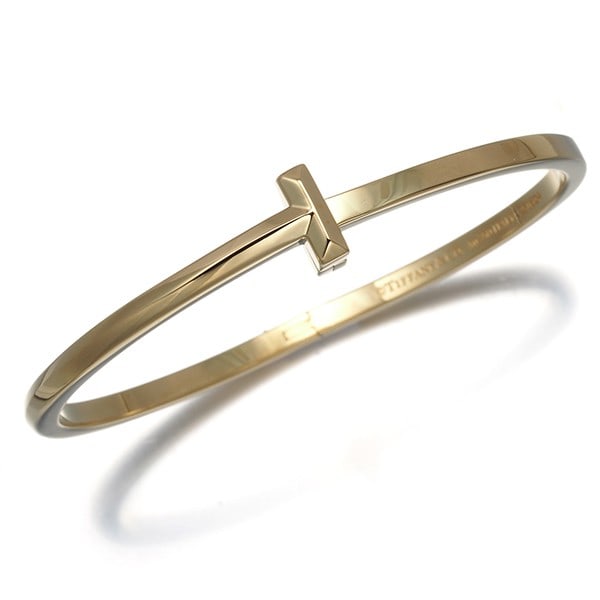 Tiffany&Co. Bracelet Tiffany T1 Narrow Bangle Hinged 18K 750 Yellow Gold: Tiffany&Co. Bracelet Tiffany T1 Narrow Bangle Hinged 18K 750 Yellow Gold Tiffany & Co.'s 18k yellow gold Tiffany T1 narrow bangle is a sleek and elegant design, featuring a hinged closure and a slende