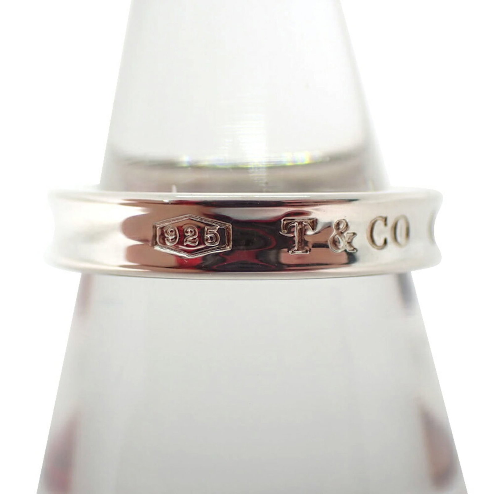 TIFFANY Band Ring Sterling Silver 925: TIFFANY Band Ring Sterling Silver 925 Sterling silver 925 band ring from Tiffany, featuring a classic design. This gently used ring shows minor signs of wear, with small scratches or light marks, but
