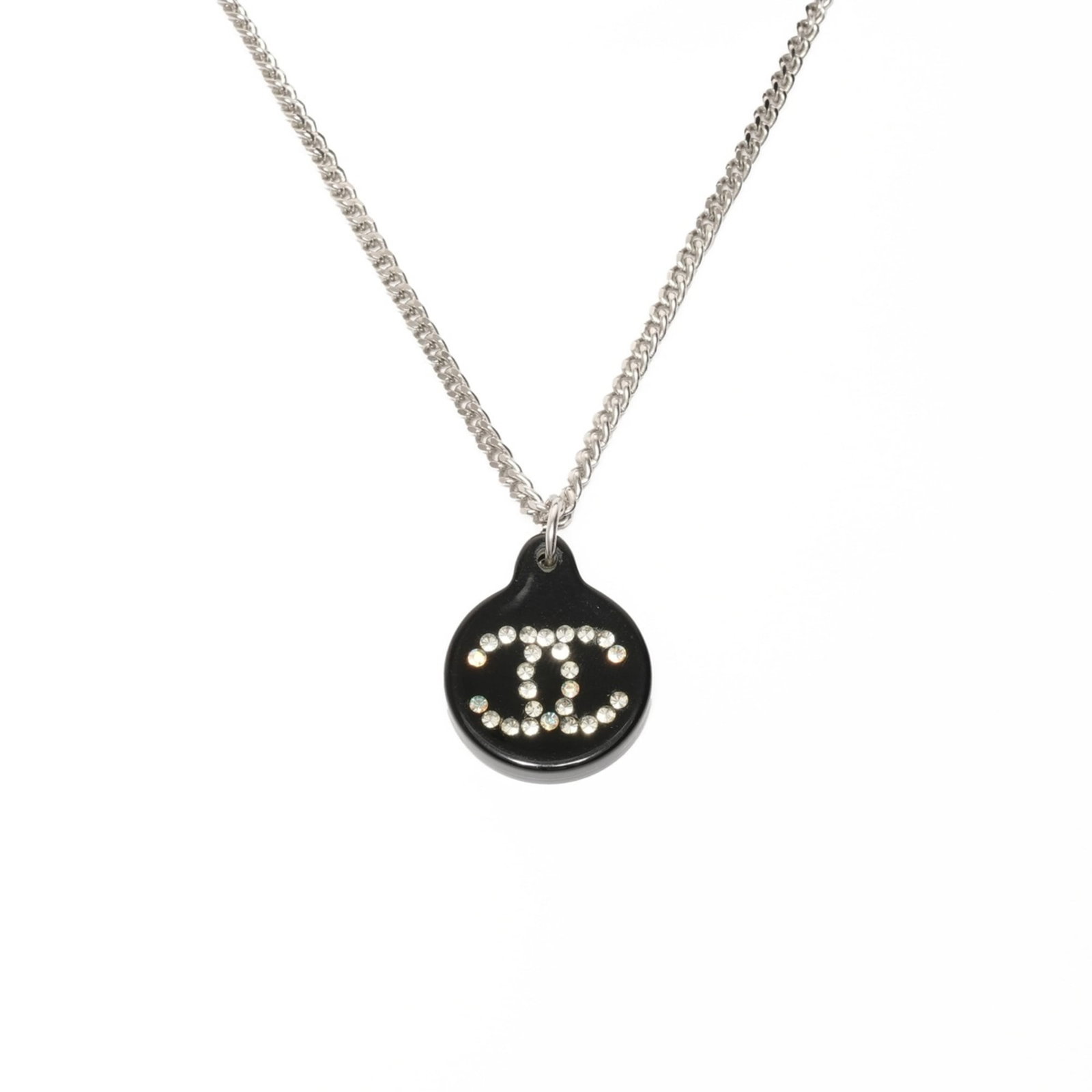 CHANEL Silver Necklace: CHANEL Silver Necklace Silver necklace from CHANEL featuring a rhinestone pendant, available in a 40 cm circumference. The necklace is in very good condition, with minor signs of wear, including small