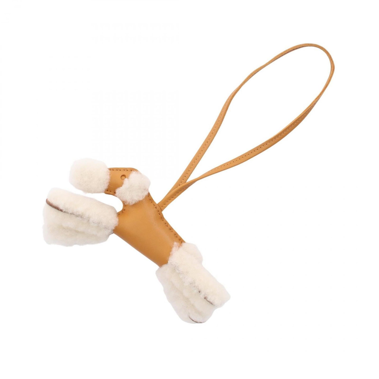 HERMES Handbag Charm Agneau Milo Fur: HERMES Handbag Charm Agneau Milo Fur Agneau Milo fur, a luxurious and soft material, is used to create this Mouton-style handbag charm from Hermes. The charm features a brown and white color scheme, w
