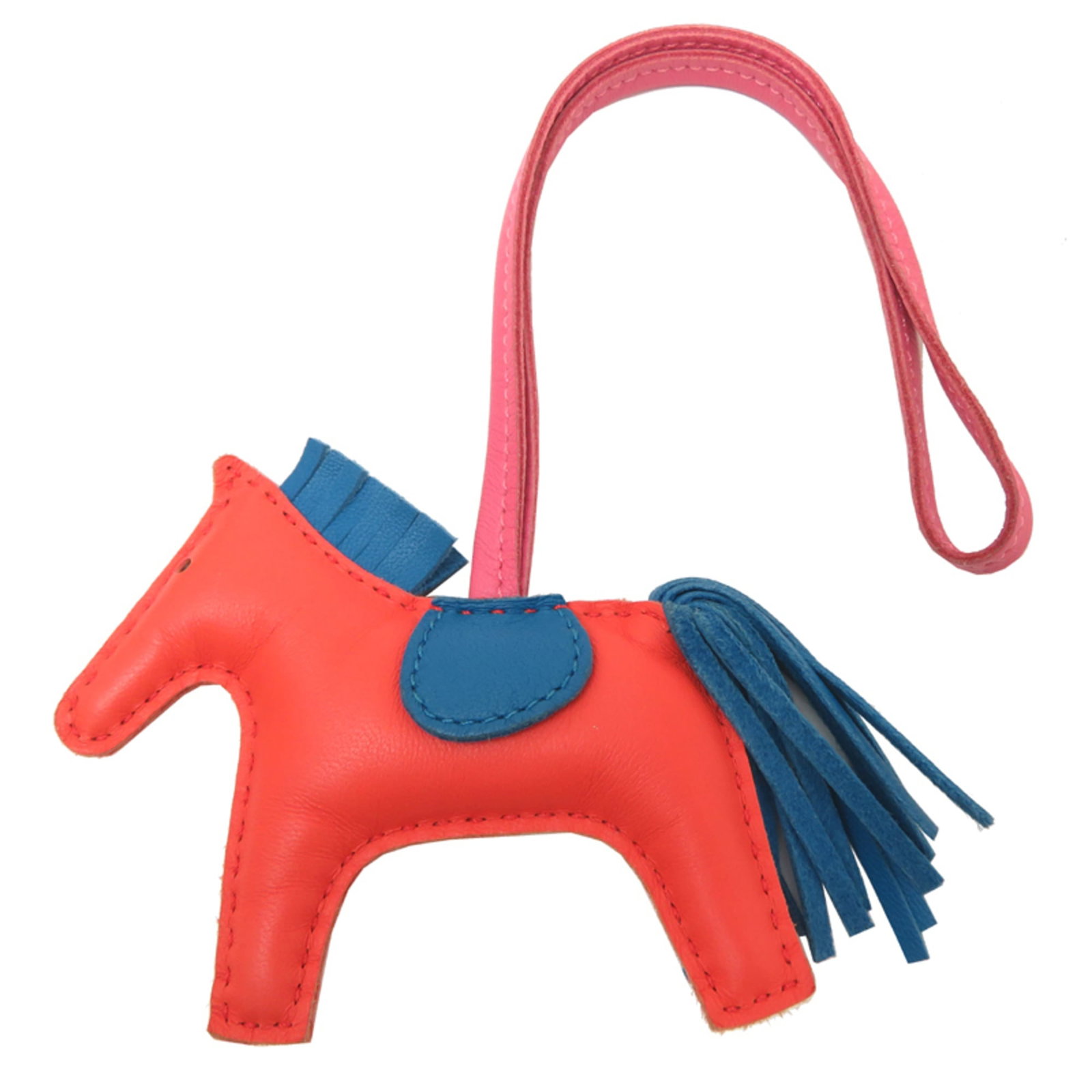 HERMES Handbag Charm Agneau Milo: HERMES Handbag Charm Agneau Milo Agneau Milo is a vibrant orange and pink agneau Milo handbag charm from the renowned French fashion house Hermes. Measuring 70mm x 95mm, this charming accessory boasts