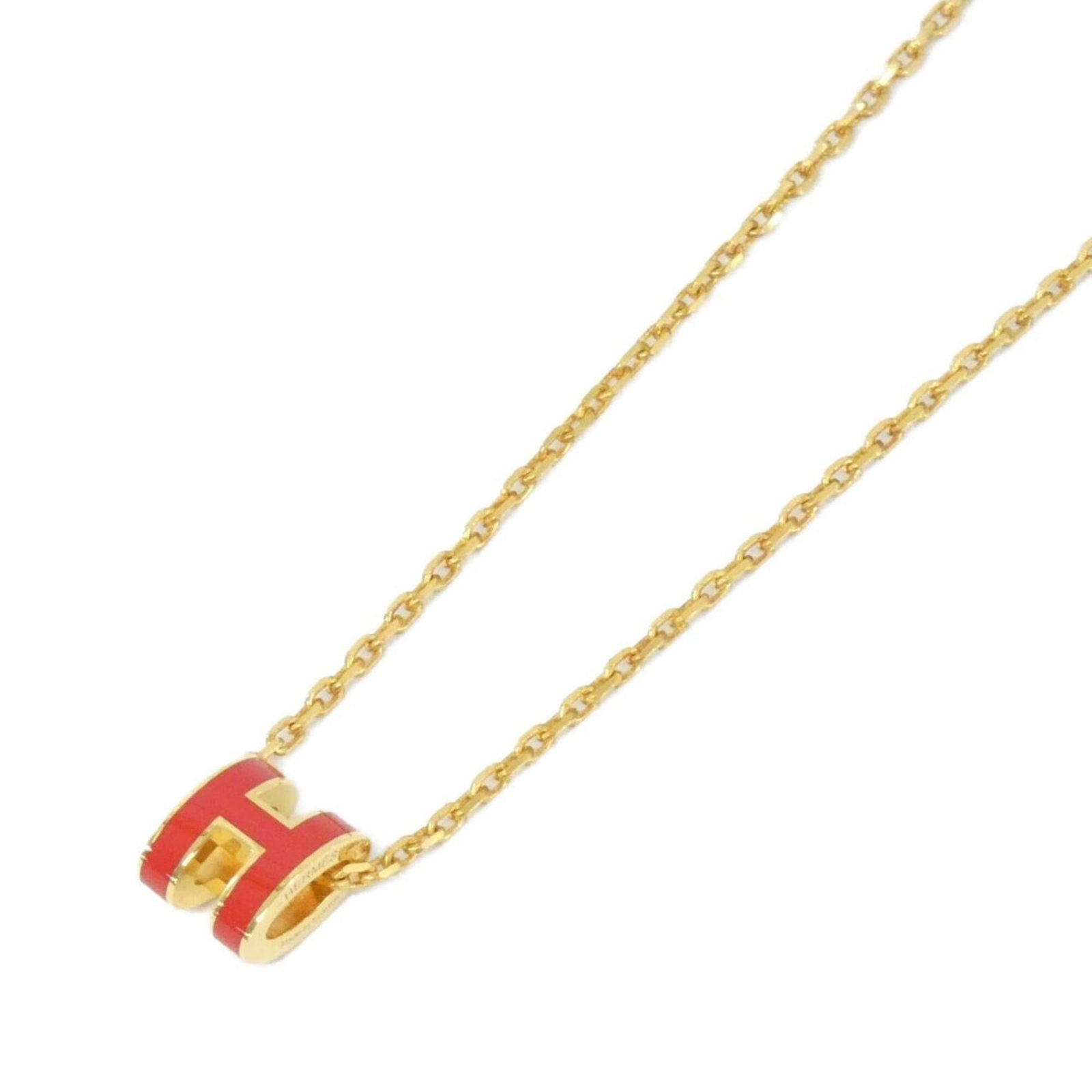 HERMES Gold Rouge Vif: HERMES Gold Rouge Vif Gold Rouge Vif necklace from Hermes, featuring a 7mm x 9mm pendant with a 40 cm chain, gently used with minor signs of wear. The necklace bears a signature and is in very good
