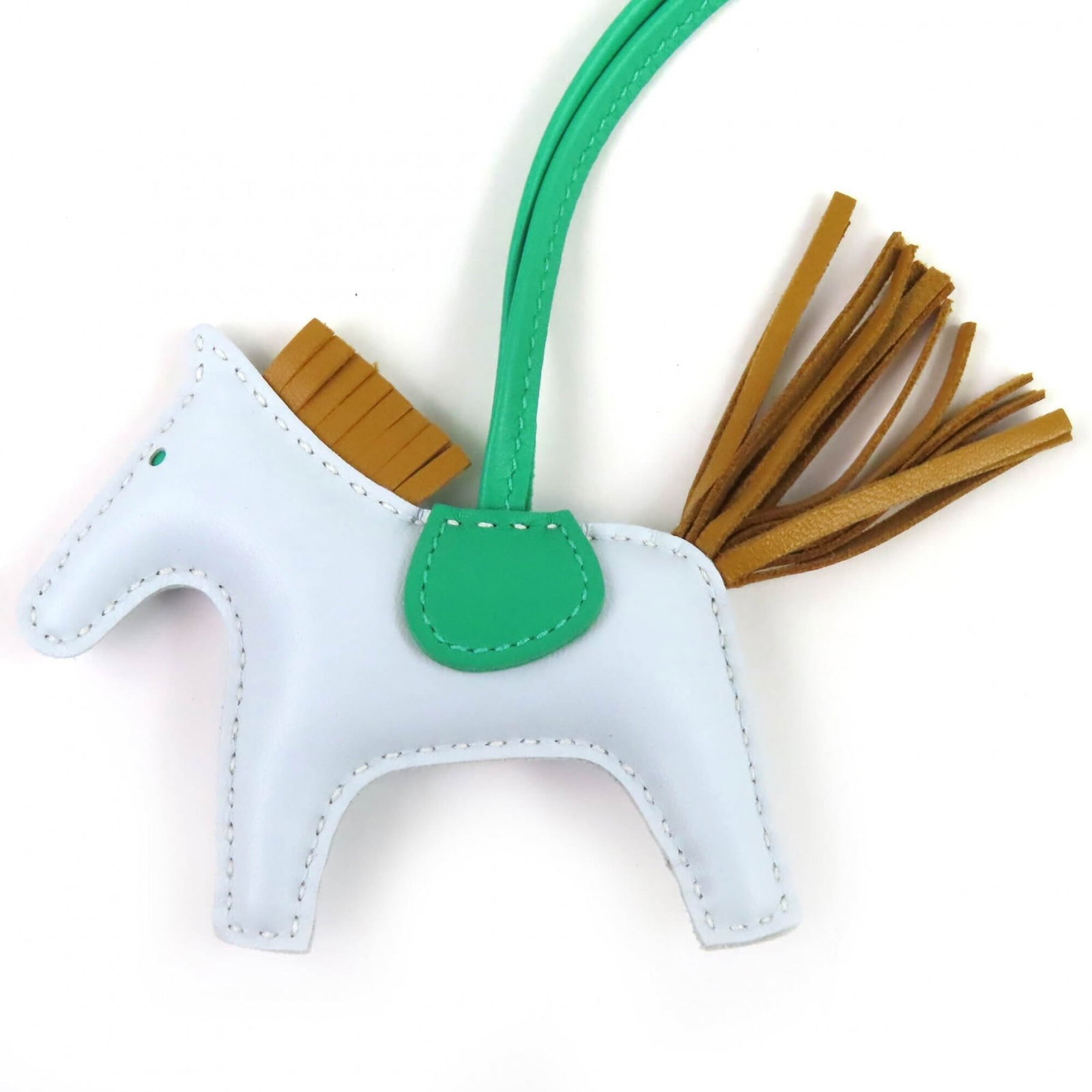 HERMES Handbag Charm Agneau Milo: HERMES Handbag Charm Agneau Milo Agneau Milo, a vibrant green agneau Milo handbag charm from the renowned French brand Hermes, adds a pop of color to any accessory collection. With a chain length of