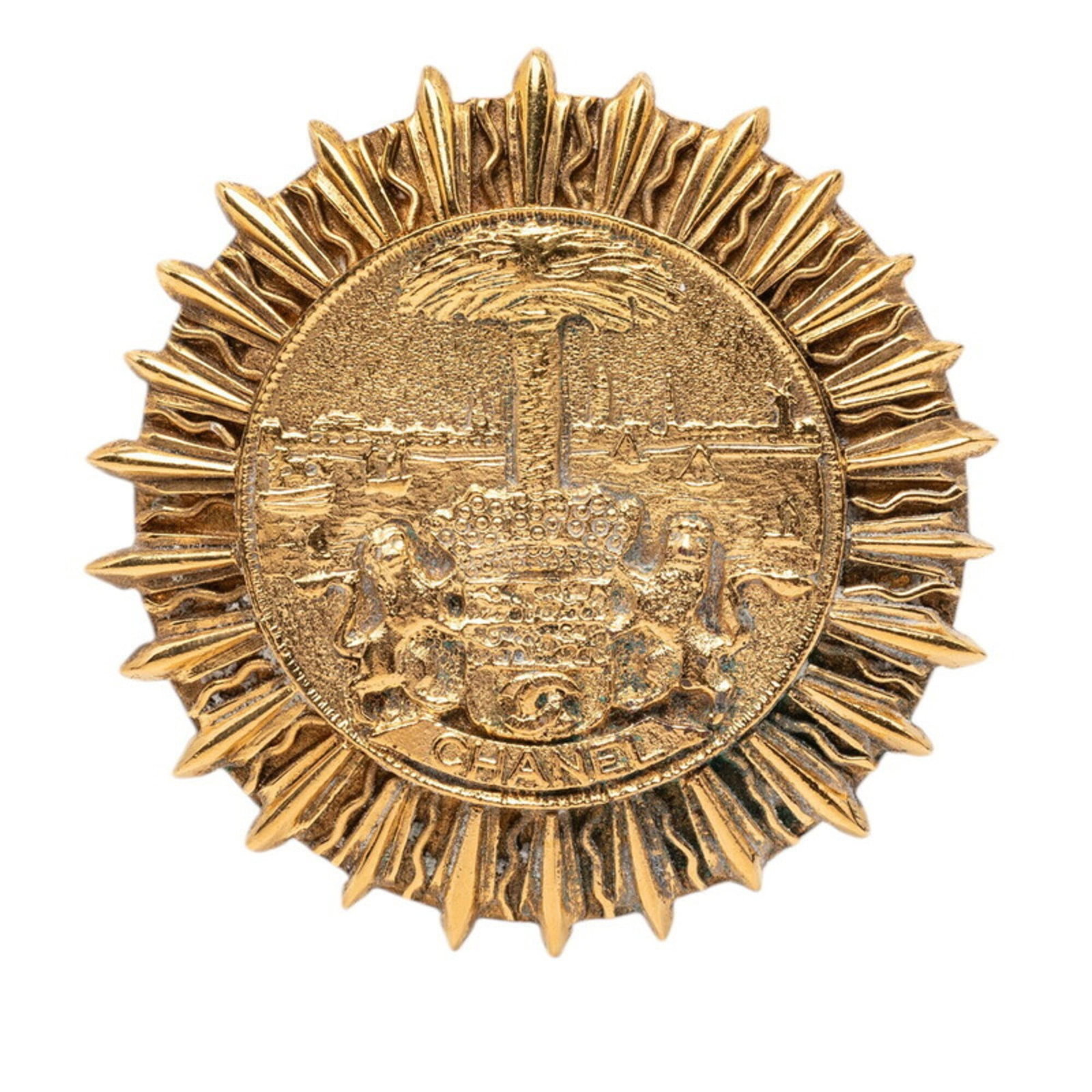 CHANEL Brooch Gold: CHANEL Brooch Gold Gold Chanel Brooch, 5.25cm x 5.25cm, Very Good Condition. This gently used brooch features a gold finish with minor signs of wear, including small scratches or light marks. The