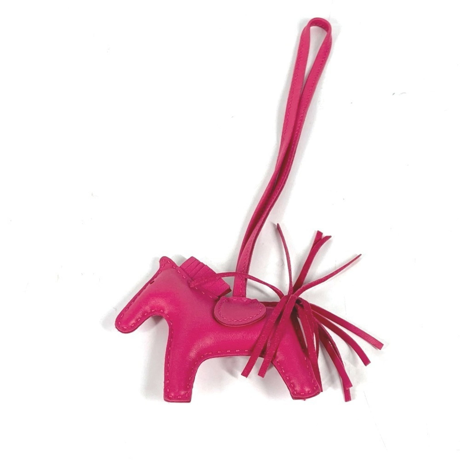HERMES Handbag Charm Agneau Milo: HERMES Handbag Charm Agneau Milo Agneau Milo is a signature material used by Hermes, known for its exceptional softness and durability. This pink Agneau Milo handbag charm boasts a delicate design,