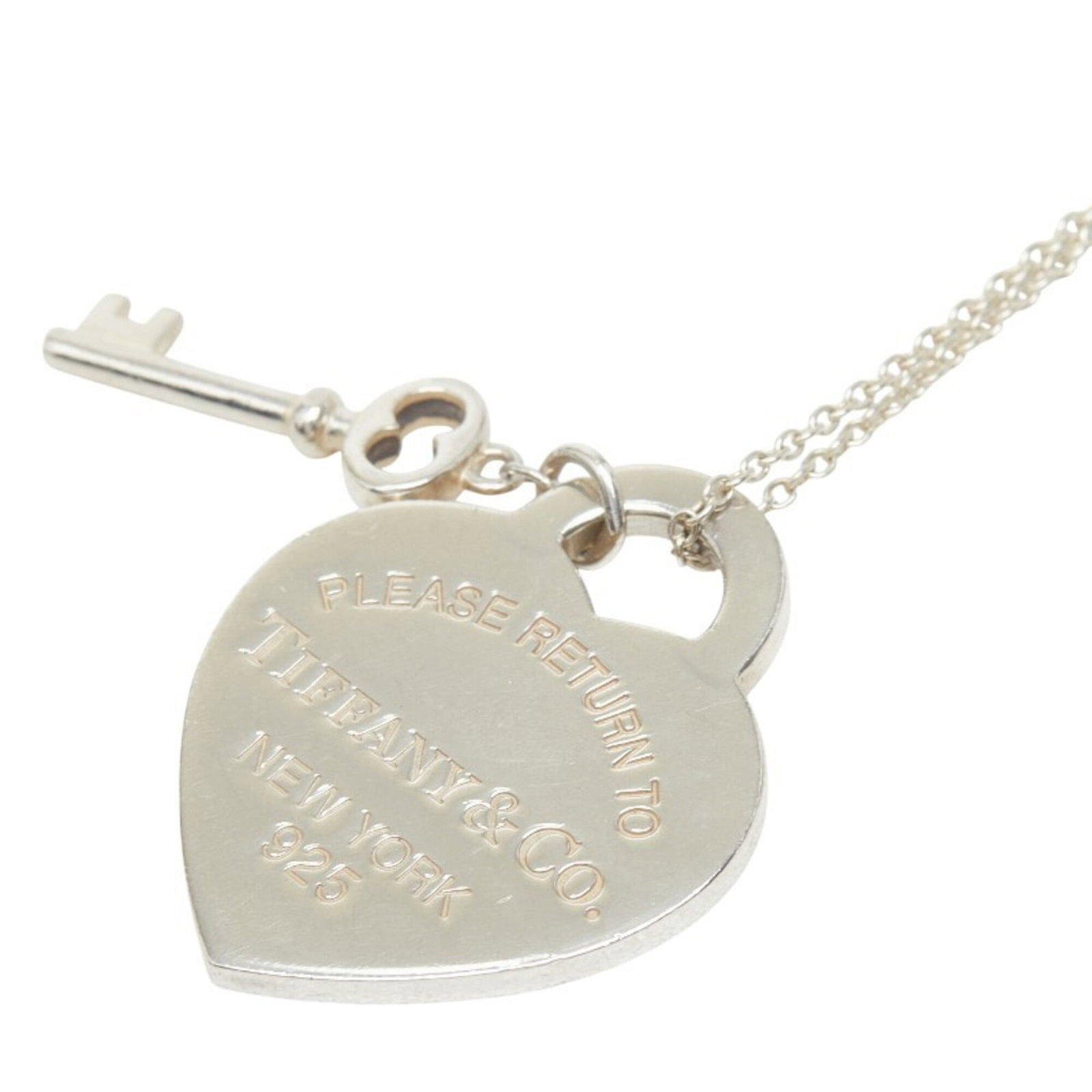 TIFFANY Silver 925: TIFFANY Silver 925 Silver 925 Tiffany Necklace with Visible Wear. This 47 cm / 18.5'' necklace features a 25.3mm x 20.7mm silver 925 pendant with visible scratches and scuffs, bearing a signature. The
