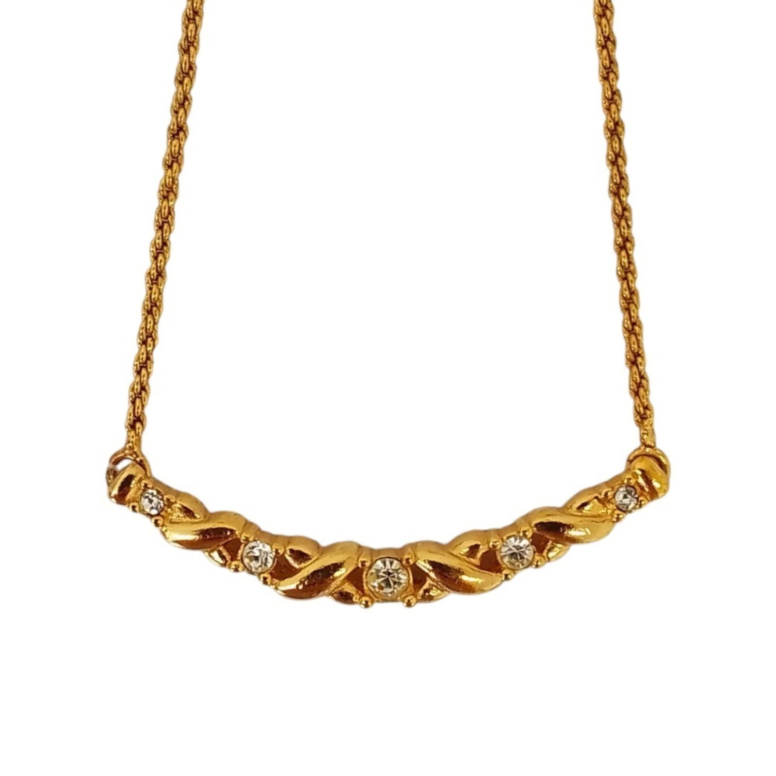 CHRISTIAN DIOR Gold: CHRISTIAN DIOR Gold Gold necklace from Christian Dior, featuring a 4mm x 40mm rhinestone pendant on a 38 cm chain, with a spring ring closure. Gently used with minor signs of wear, this necklace is in