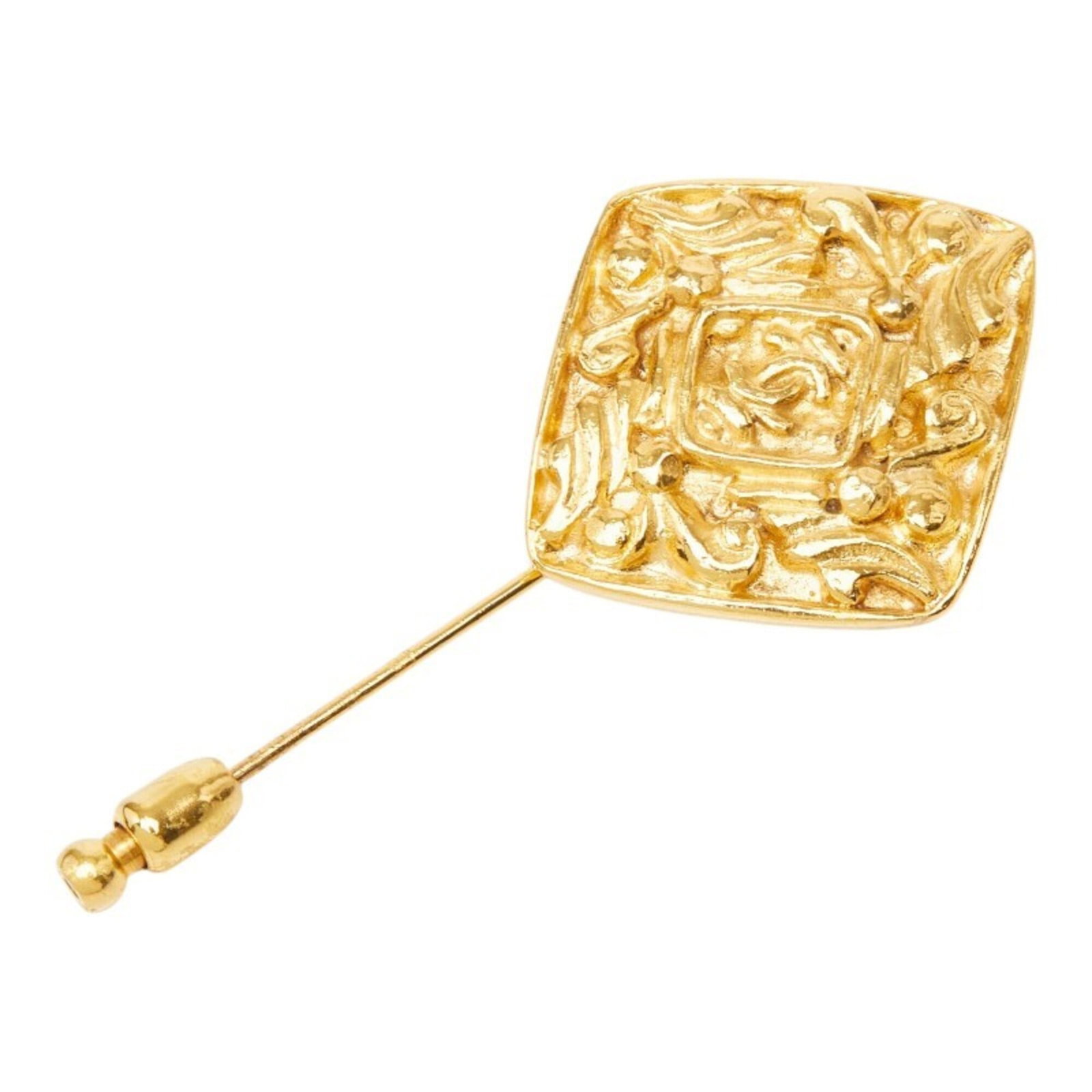 CHANEL Brooch Gold: CHANEL Brooch Gold Gold Chanel Brooch, featuring a 28.20mm x 31.40mm stone, is a statement piece with visible scratches and scuffs. This pre-owned brooch is in good condition, with a worn appearance