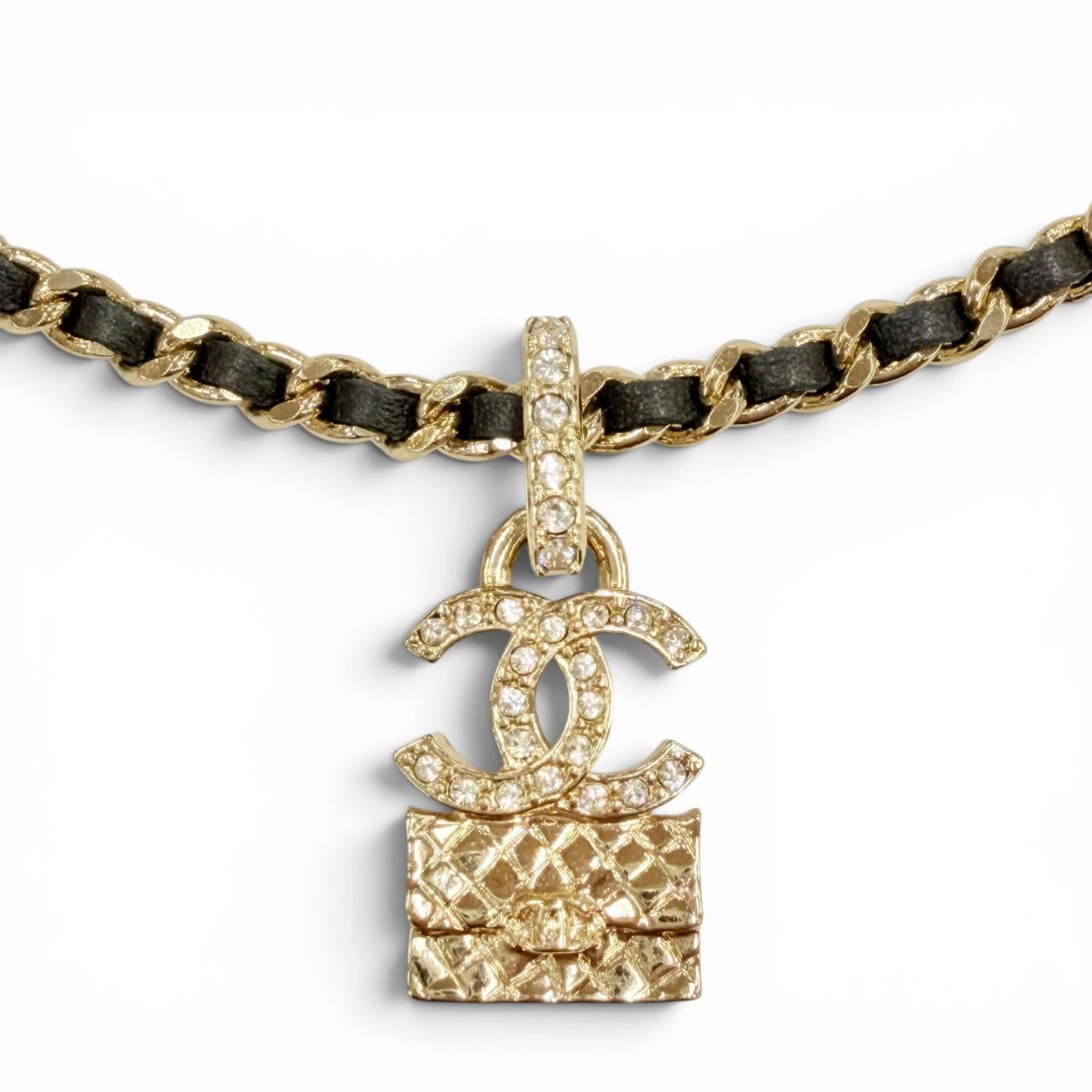 CHANEL Rhinestone Black Gold: CHANEL Rhinestone Black Gold Black Gold Rhinestones adorn this elegant Chanel necklace, adding a touch of luxury to any outfit. The necklace features a 30mm x 14mm pendant and adjustable neck
