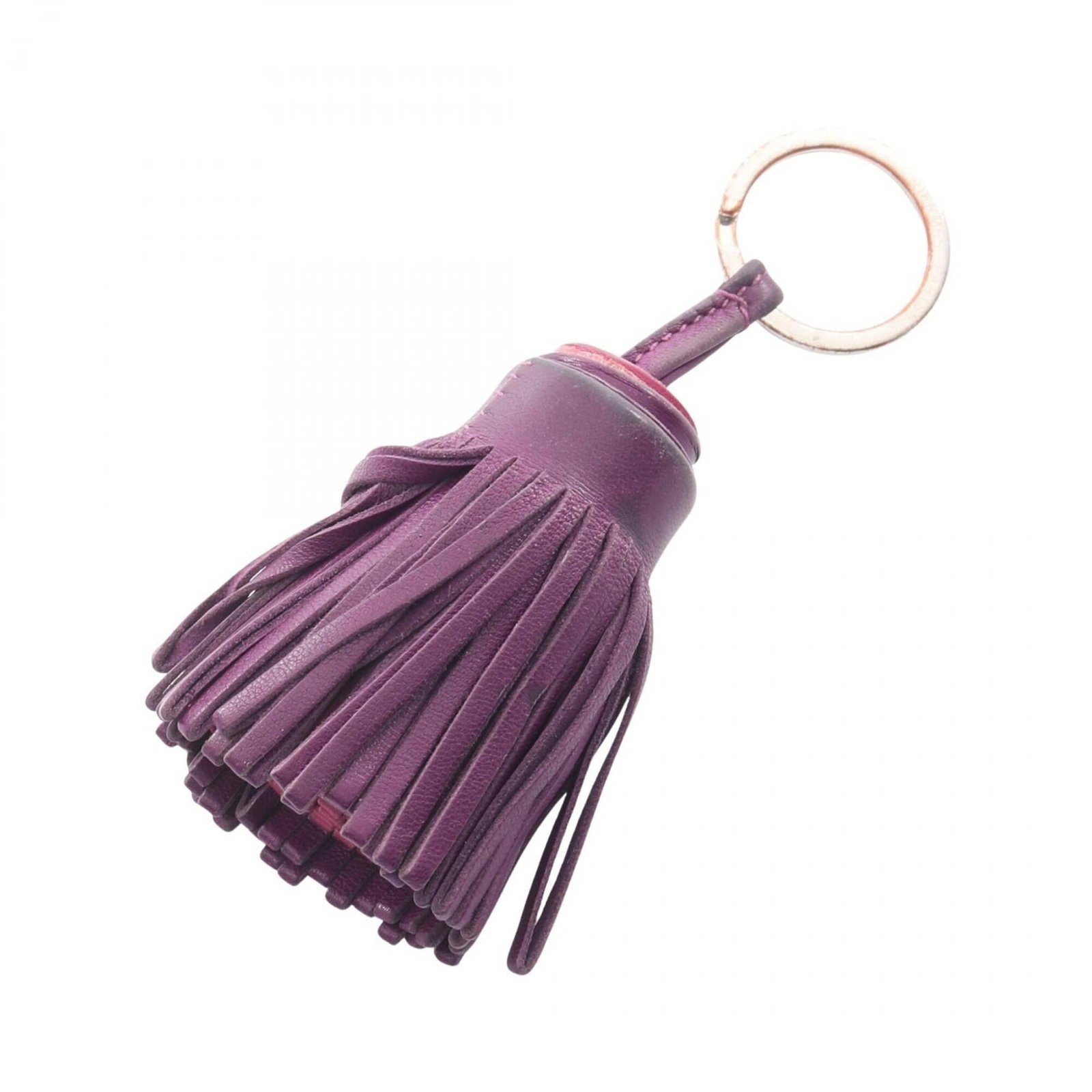 HERMES Handbag Charm Agneau Milo: HERMES Handbag Charm Agneau Milo Agneau Milo handbag charm from Herm?s, featuring a rich purple hue. This charm boasts visible wear, including scratches and scuffs, but remains fully functional. Its