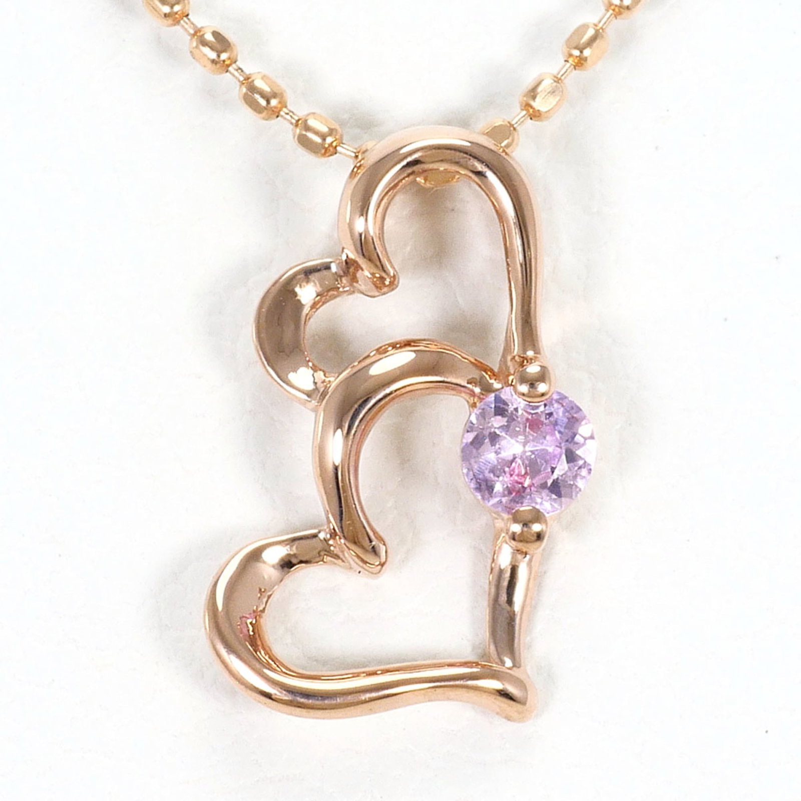 Pink Gold (10K): Pink Gold (10K) Pink gold (10K) tourmaline necklace in excellent condition, featuring a 12mm x 7mm pendant and a 40 cm chain. This necklace boasts a beautiful pink hue and a durable 10K metal