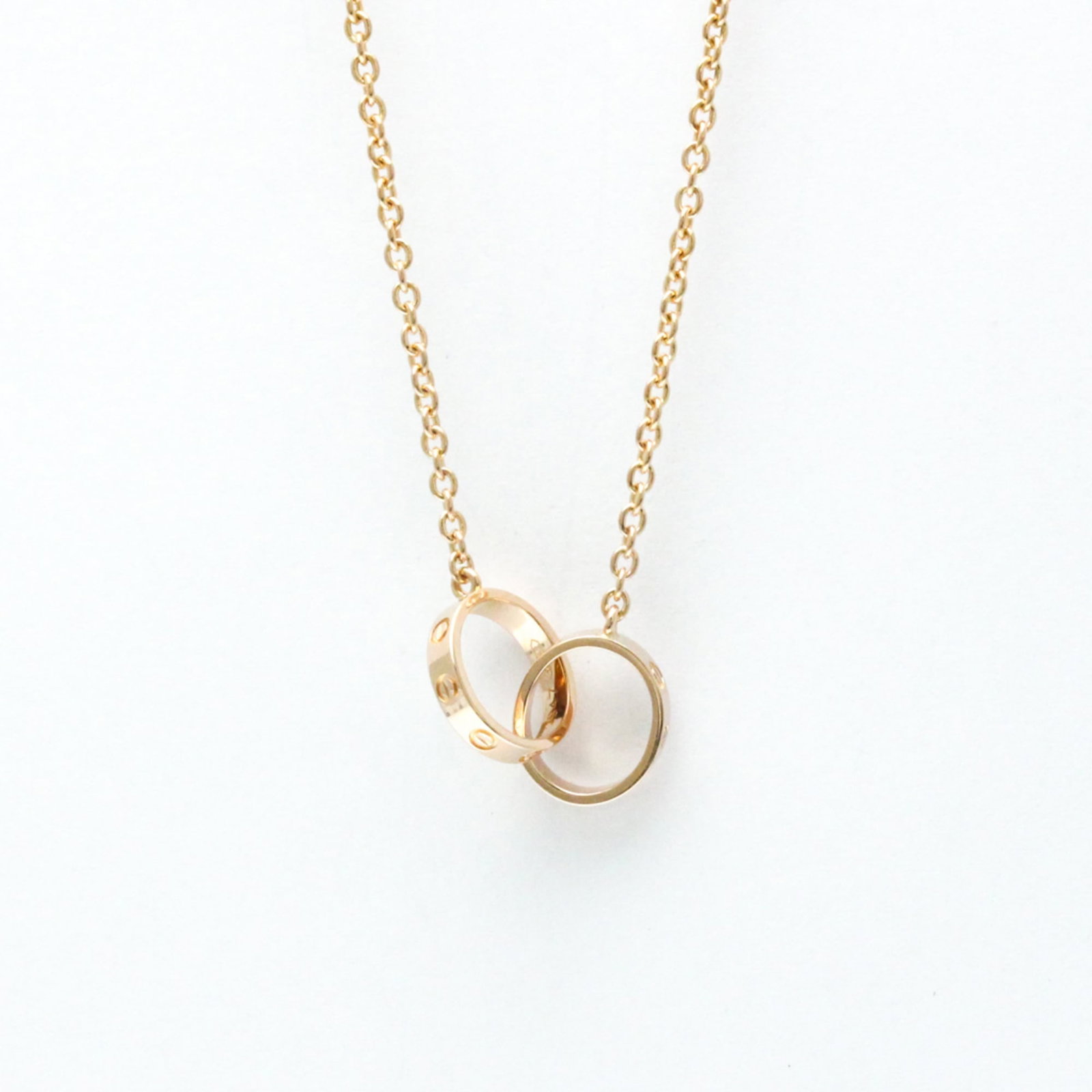 CARTIER Pink Gold (18K): CARTIER Pink Gold (18K) Pink gold (18K) pendant necklace from Cartier's Love collection, featuring a 9.7mm x 11mm pendant with a 44 cm chain. This gently used necklace showcases a subtle pink gold