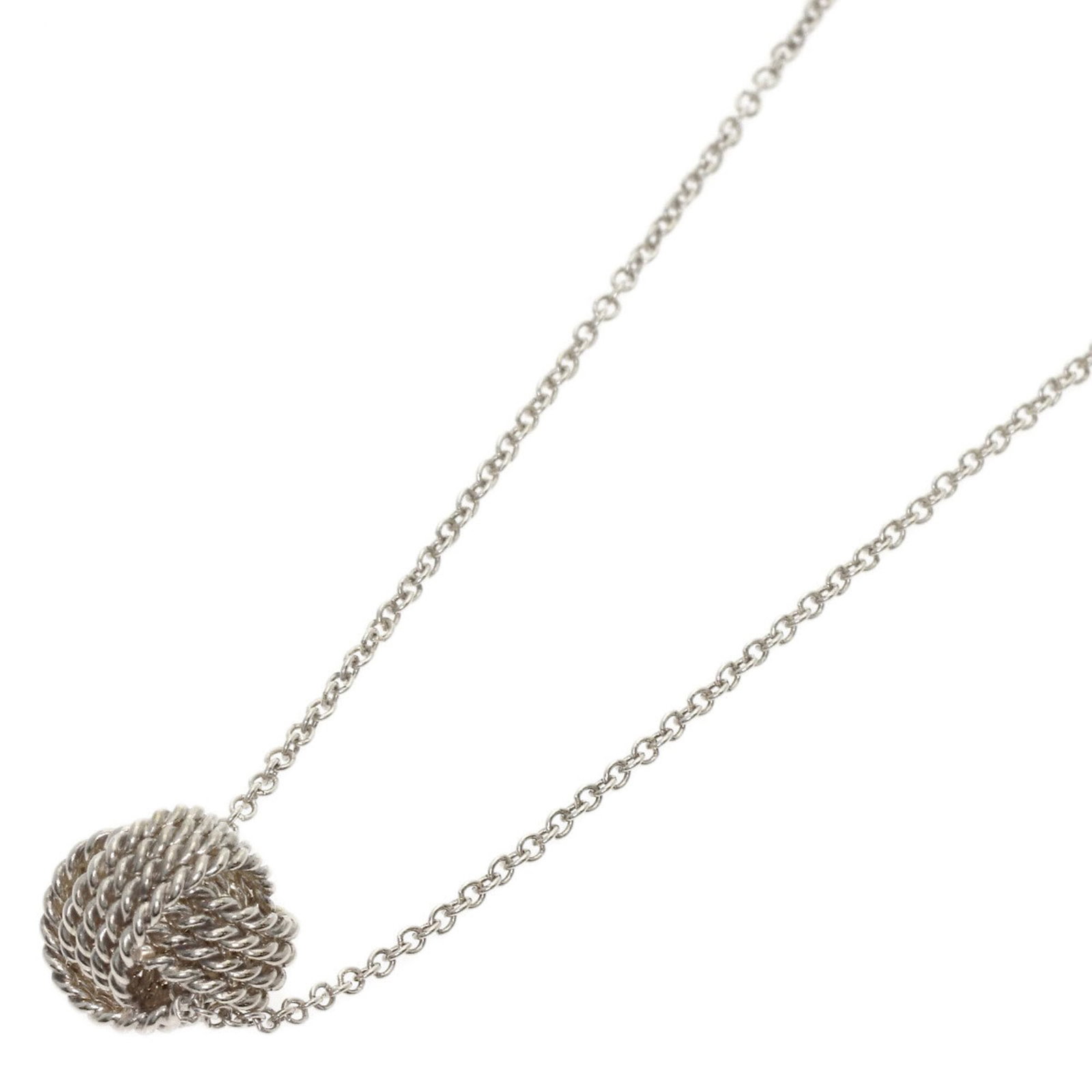 TIFFANY Silver Necklace: TIFFANY Silver Necklace The Tiffany Silver Necklace is a beautiful piece featuring a silver pendant with a 8.7mm x 8.4mm design. Gently used with minor signs of wear, this necklace has a 40.5 cm / 15.