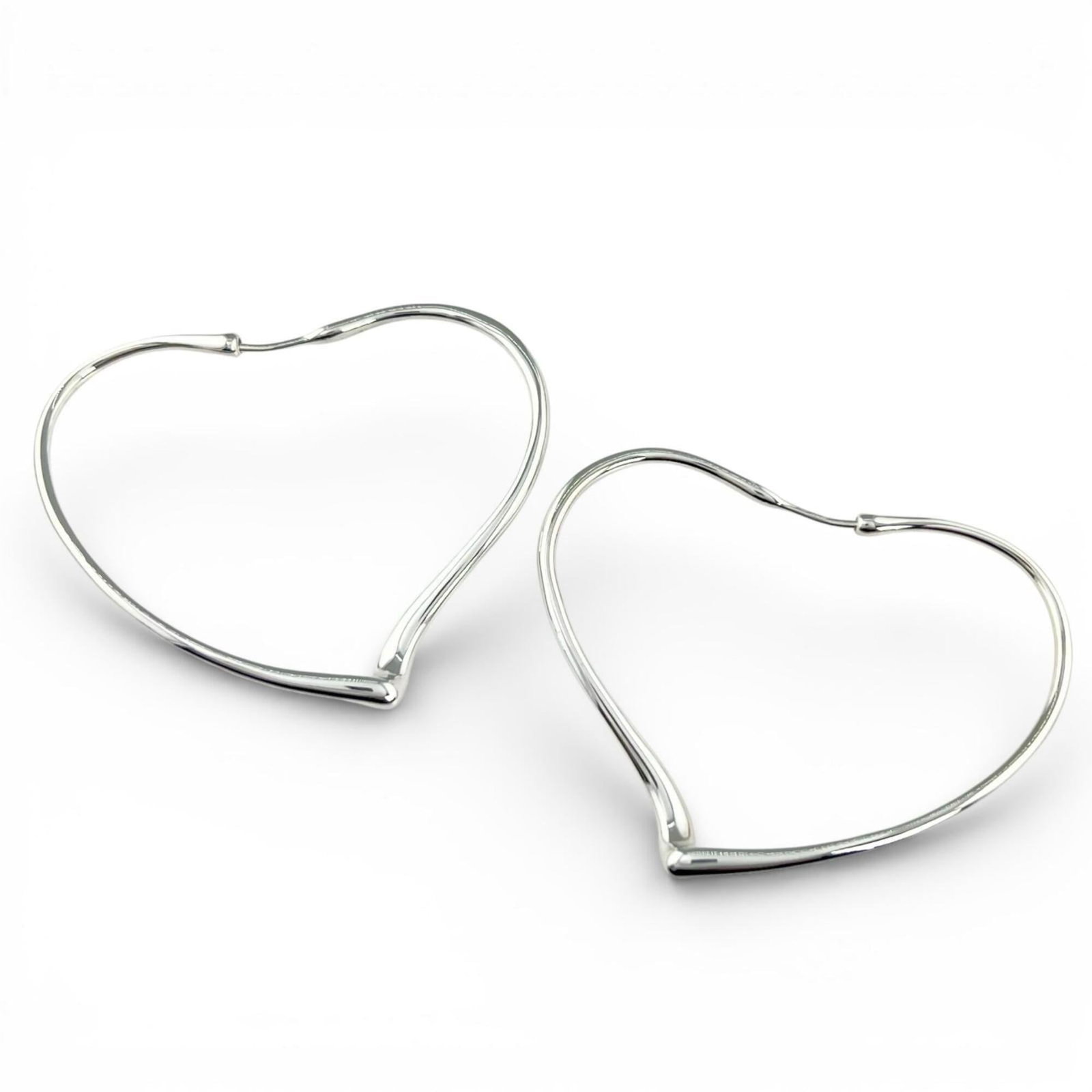 TIFFANY Hoop Earrings Silver 925: TIFFANY Hoop Earrings Silver 925 Silver 925 Tiffany Hoop Earrings with a sleek Open Heart design, crafted for a timeless and elegant look. Measuring 55.00mm x 60.00mm, these earrings boast a substanti