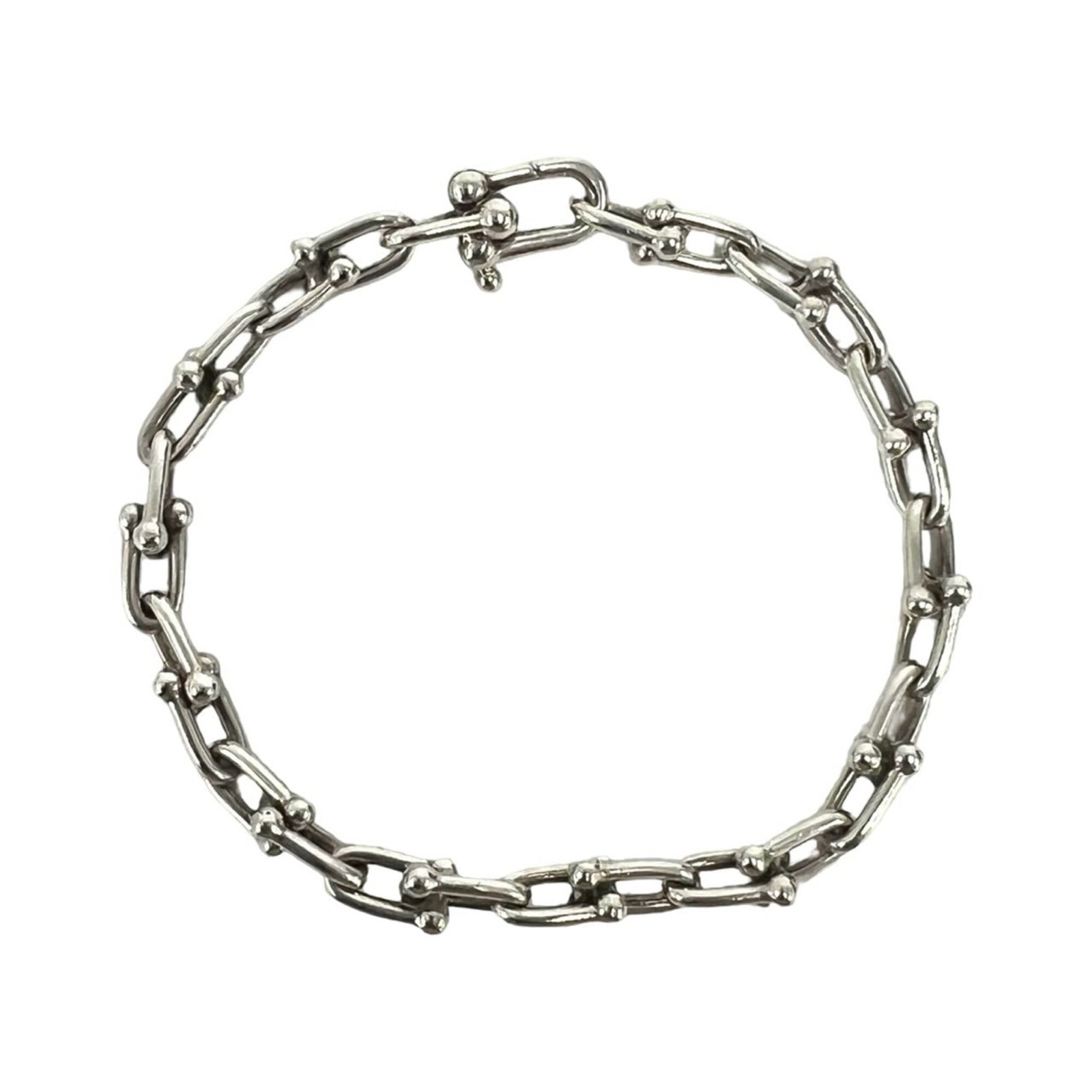 TIFFANY Charm Bracelet Silver 925: TIFFANY Charm Bracelet Silver 925 Silver 925 Tiffany charm bracelet with visible scratches and scuffs, offering a unique, pre-owned piece with character. This 18.5cm charm bracelet features a silver 9