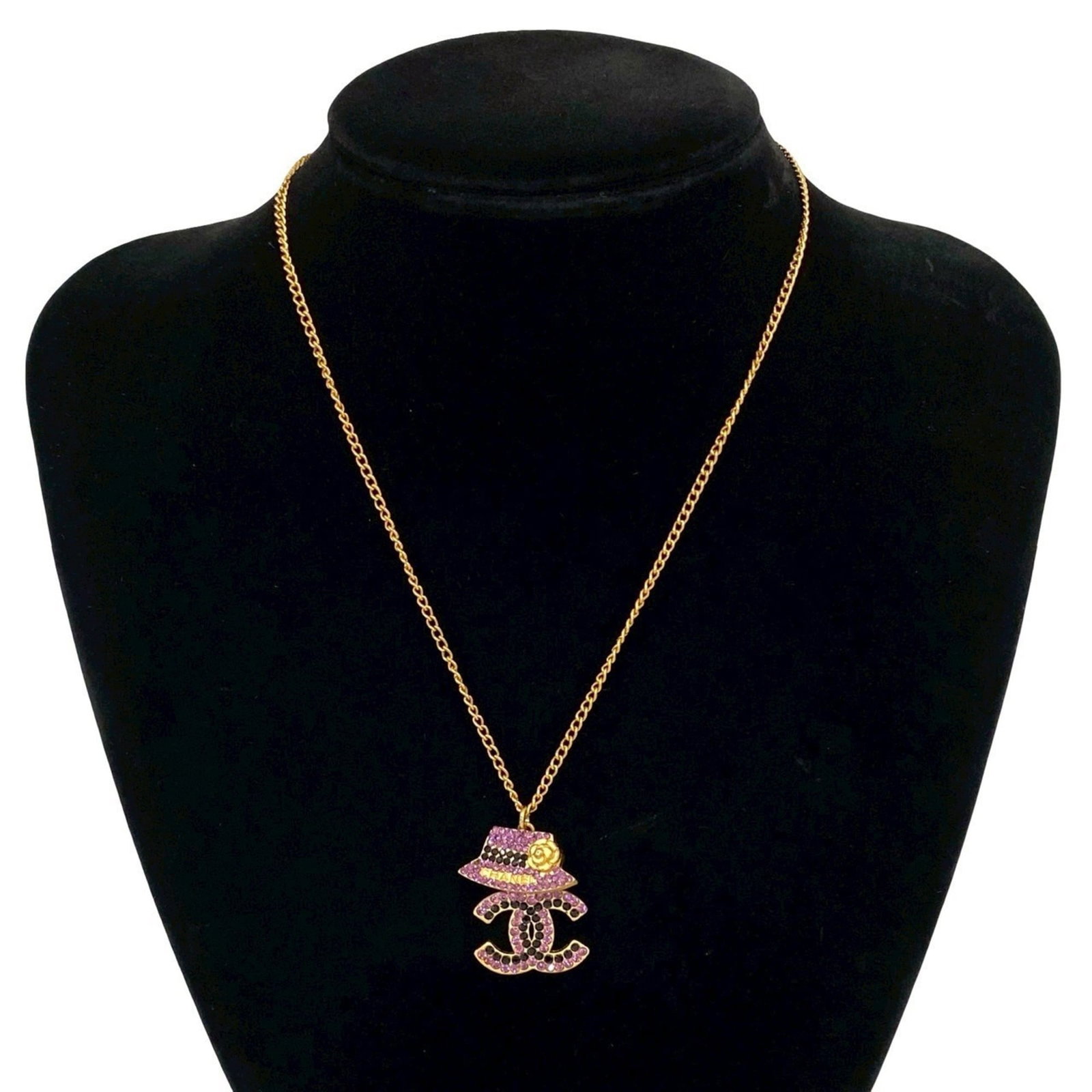 CHANEL Gold Plating: CHANEL Gold Plating Gold plating on a Chanel necklace pendant in black, gold, and purple, featuring rhinestone accents, is available. The necklace has a 41.5 cm circumference and is in good used