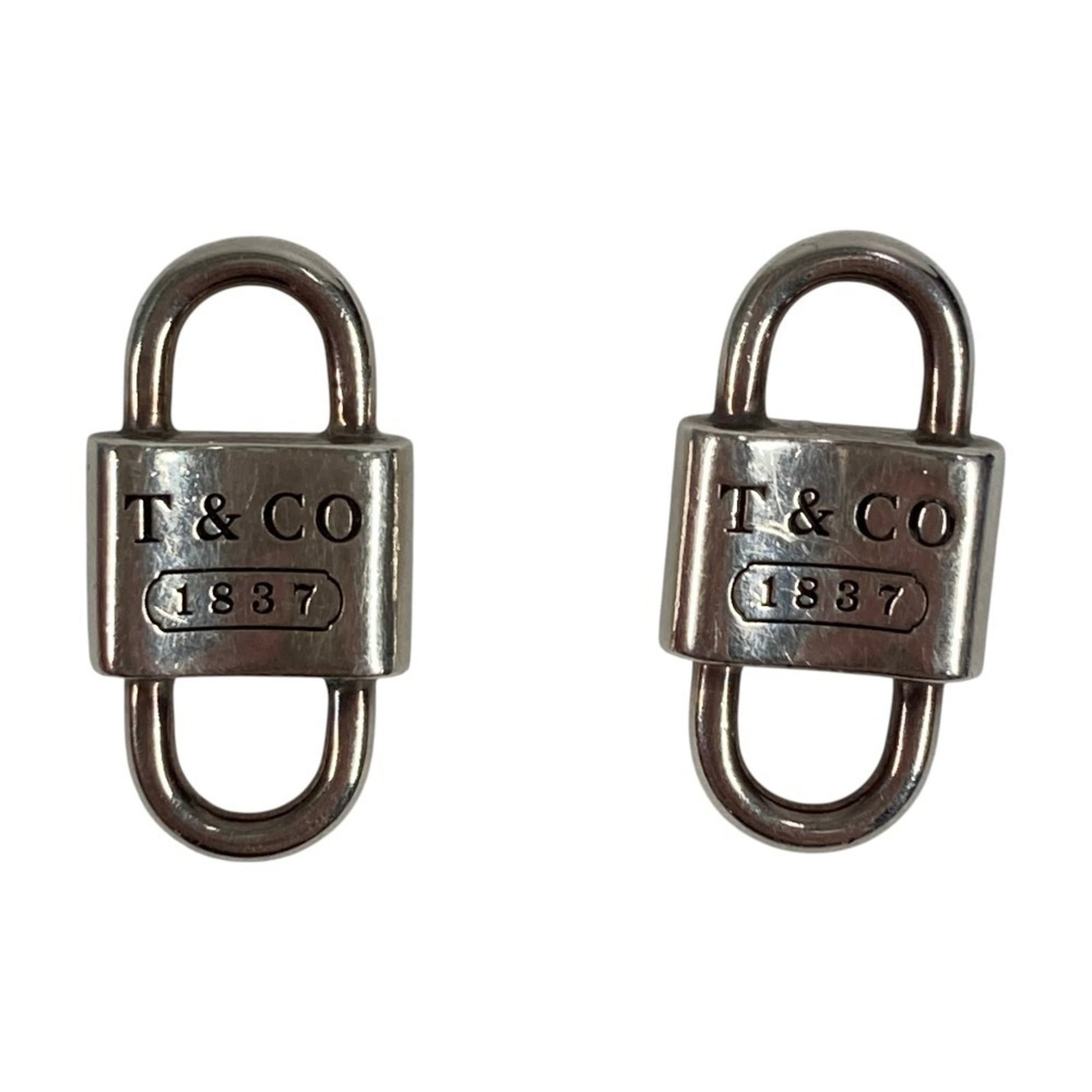 TIFFANY Stud Earrings Silver 925: TIFFANY Stud Earrings Silver 925 Silver 925 stud earrings from Tiffany, bearing a signature, are available. The earrings feature a silver finish with visible scratches and scuffs, and are in good over