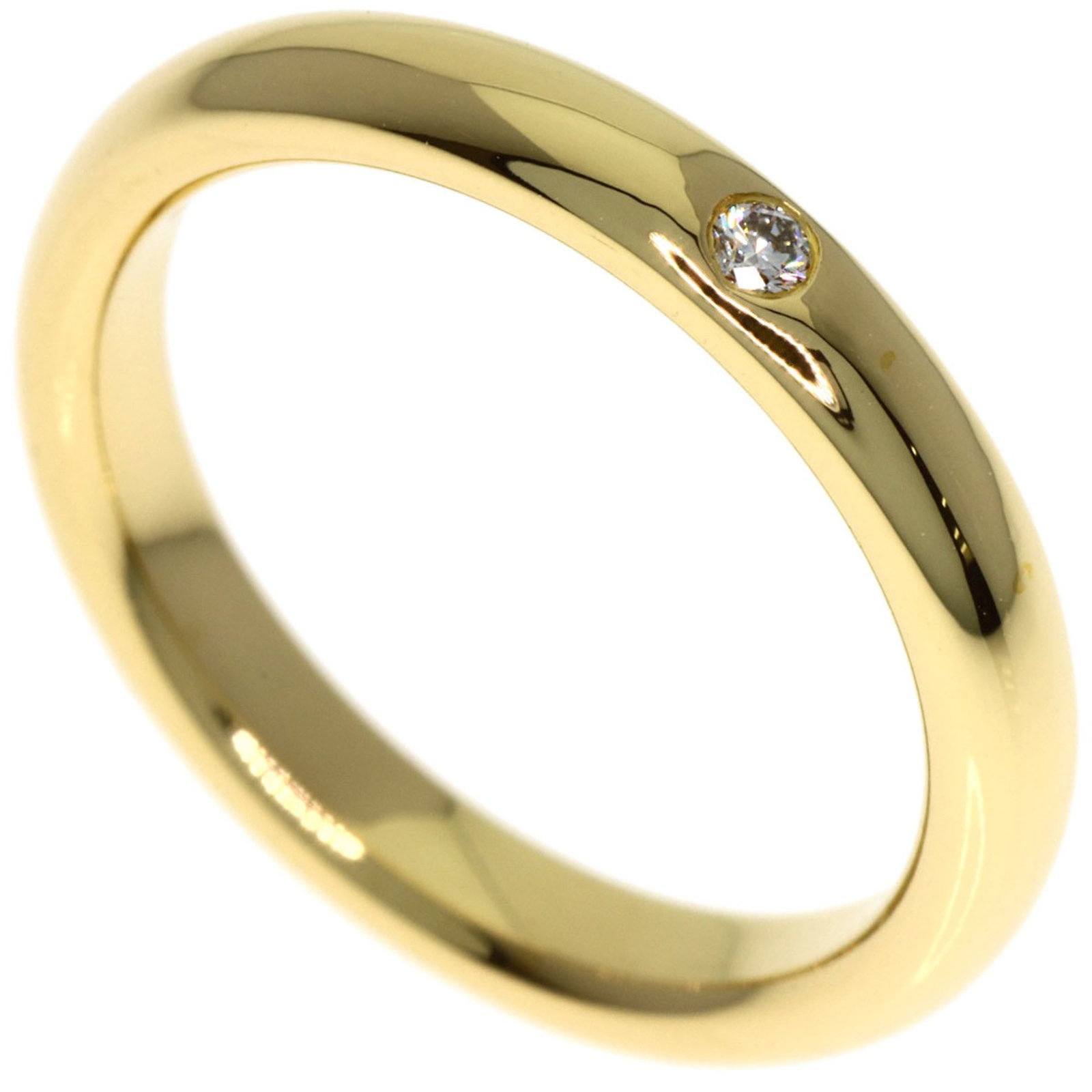 TIFFANY Band Ring Yellow Gold (18K): TIFFANY Band Ring Yellow Gold (18K) Yellow gold (18K) band ring from Tiffany, featuring a diamond stone, is a gently used piece in very good condition. The ring bears minor signs of wear, with small s