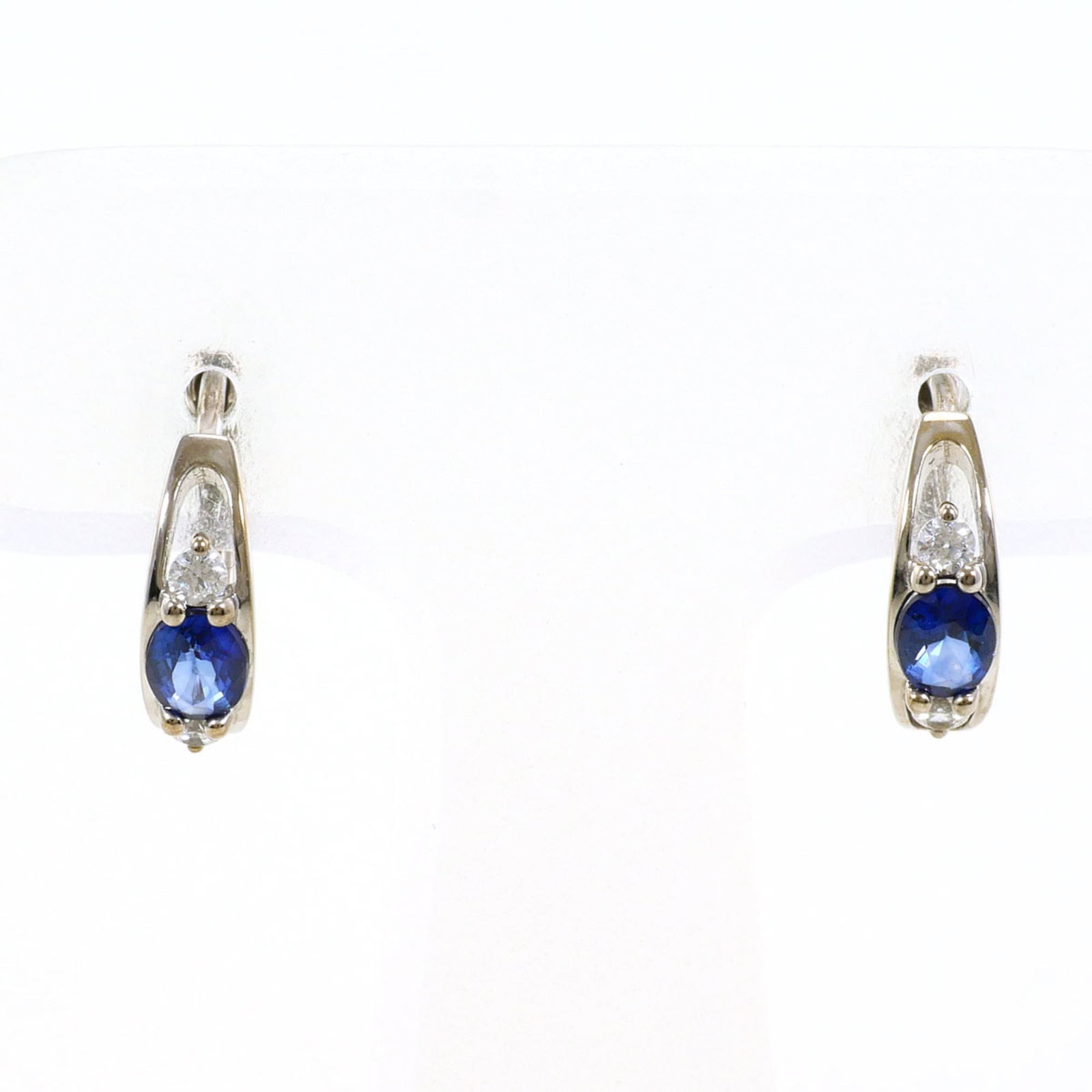 Hoop Earrings White Gold (10K): Hoop Earrings White Gold (10K) White gold hoop earrings with a subtle shine, featuring cubic zirconia and sapphire accents, crafted from 10K white gold. Weighing 1.5g, these earrings are made to last