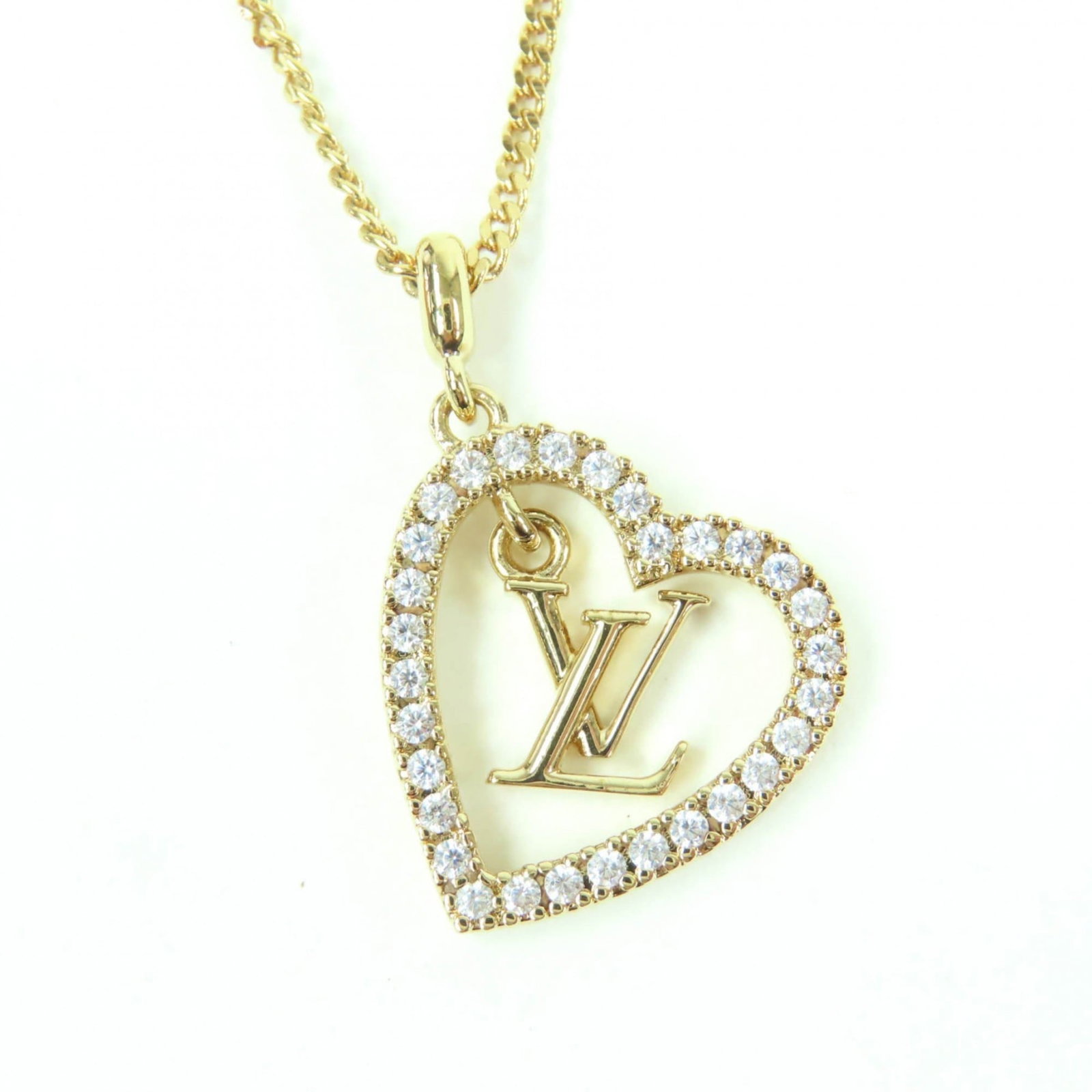LOUIS VUITTON Gold: LOUIS VUITTON Gold Gold necklace with a 25mm x 15mm rhinestone pendant, available in a range of 38 cm - 44 cm neck circumferences, presented in a Louis Vuitton box and dust bag. This like-new used