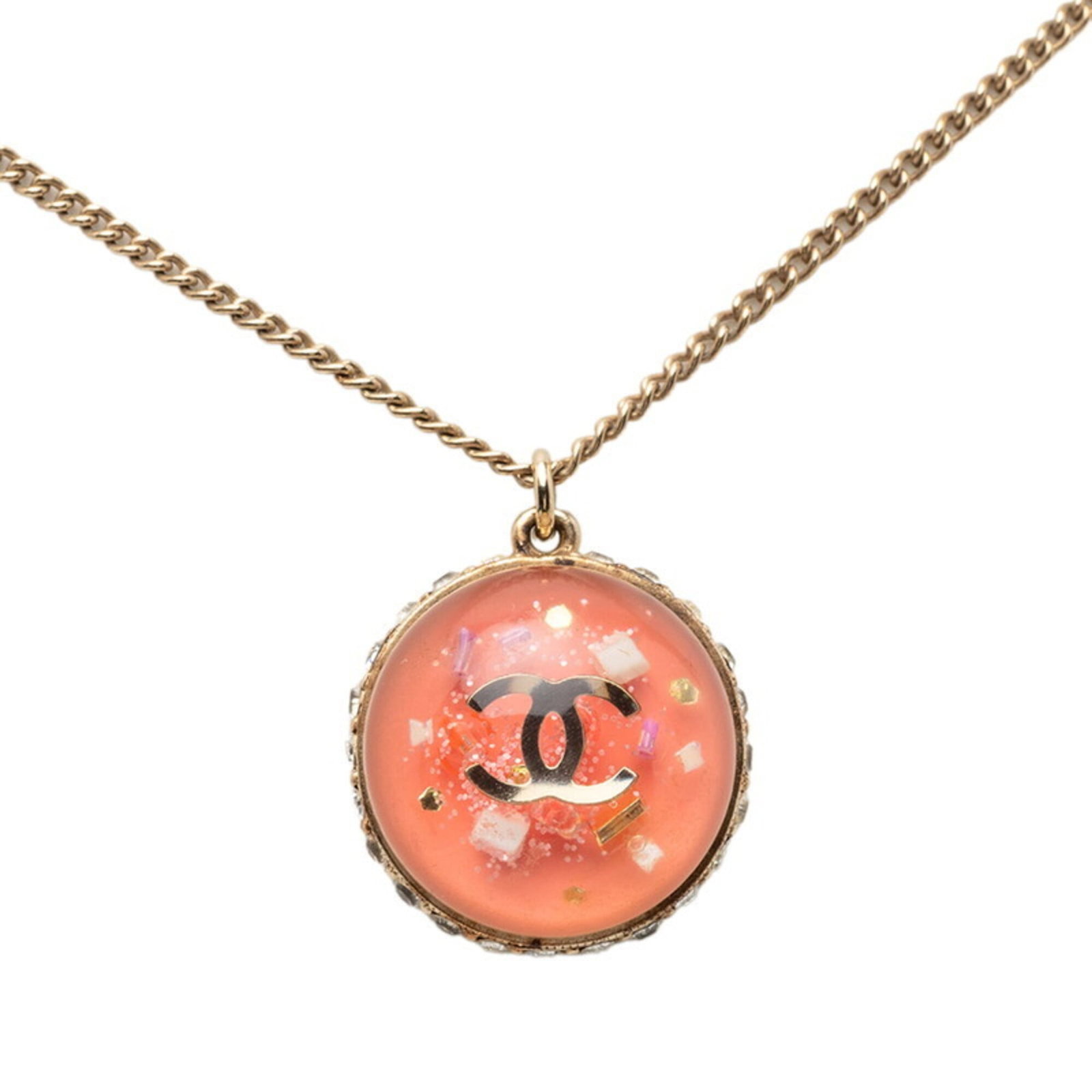 CHANEL Gold Plating: CHANEL Gold Plating Gold Plating from the iconic fashion brand Chanel, this necklace features a 48 cm chain and a 24.1mm x 21.7mm rhinestone pendant with a pink stone. The item boasts a luxurious