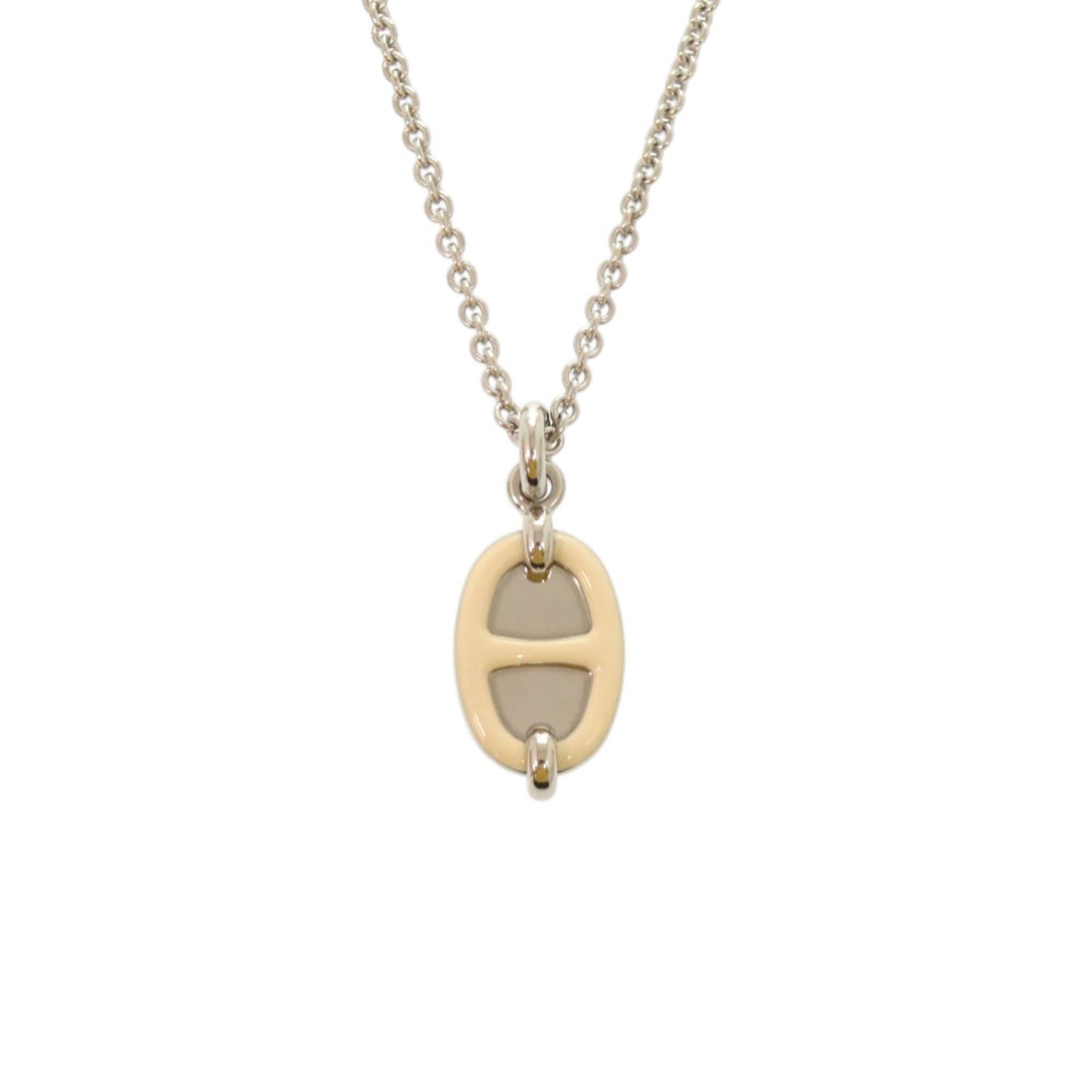 HERMES Metal Cream Silver: HERMES Metal Cream Silver The Hermes Metal Cream Silver necklace boasts a sleek, silver pendant with a subtle cream hue, perfectly complemented by its slender chain. This elegant piece is designed to