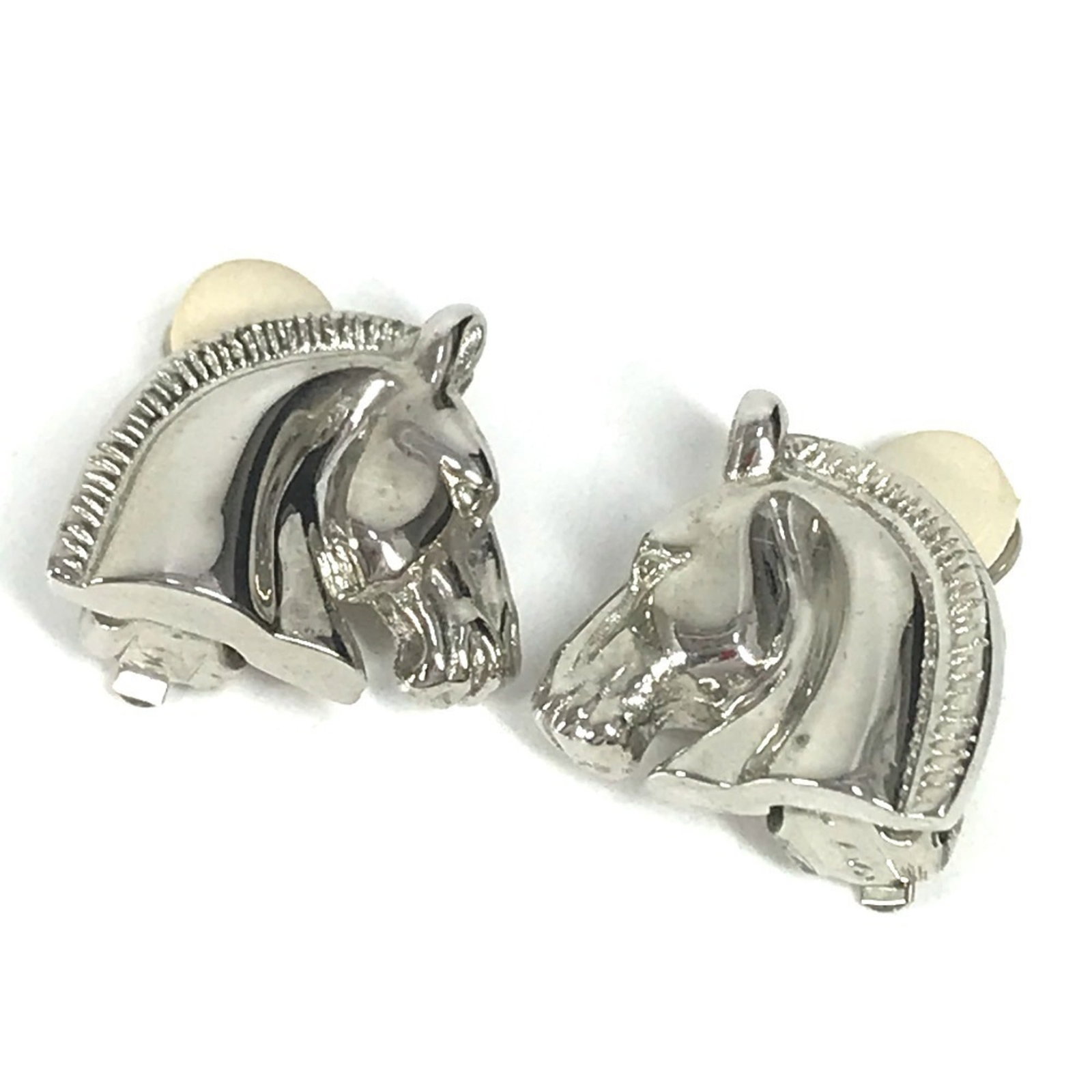 HERMES Clip Earrings Metal: HERMES Clip Earrings Metal Silver Hermes Clip Earrings with visible scratches and scuffs, bearing a signature. Made from metal, these clip earrings showcase the iconic Hermes design. In good used cond