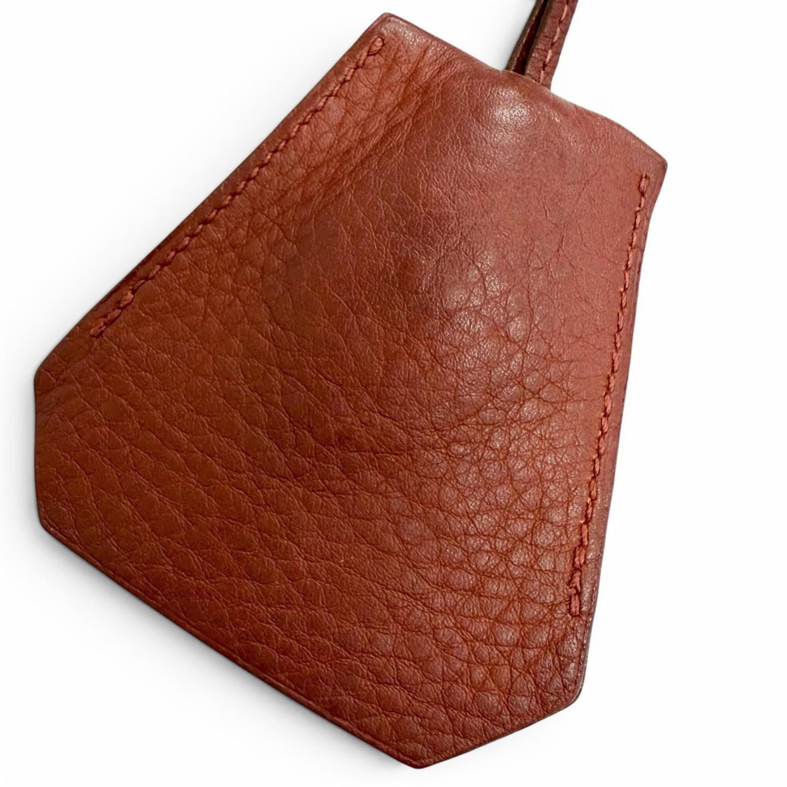 HERMES Leather Rouge H: HERMES Leather Rouge H The Hermes Leather Rouge H necklace boasts a striking design with a 80mm x 76mm leather pendant in the iconic Rouge H color. This men's necklace features a 94 cm / 37''