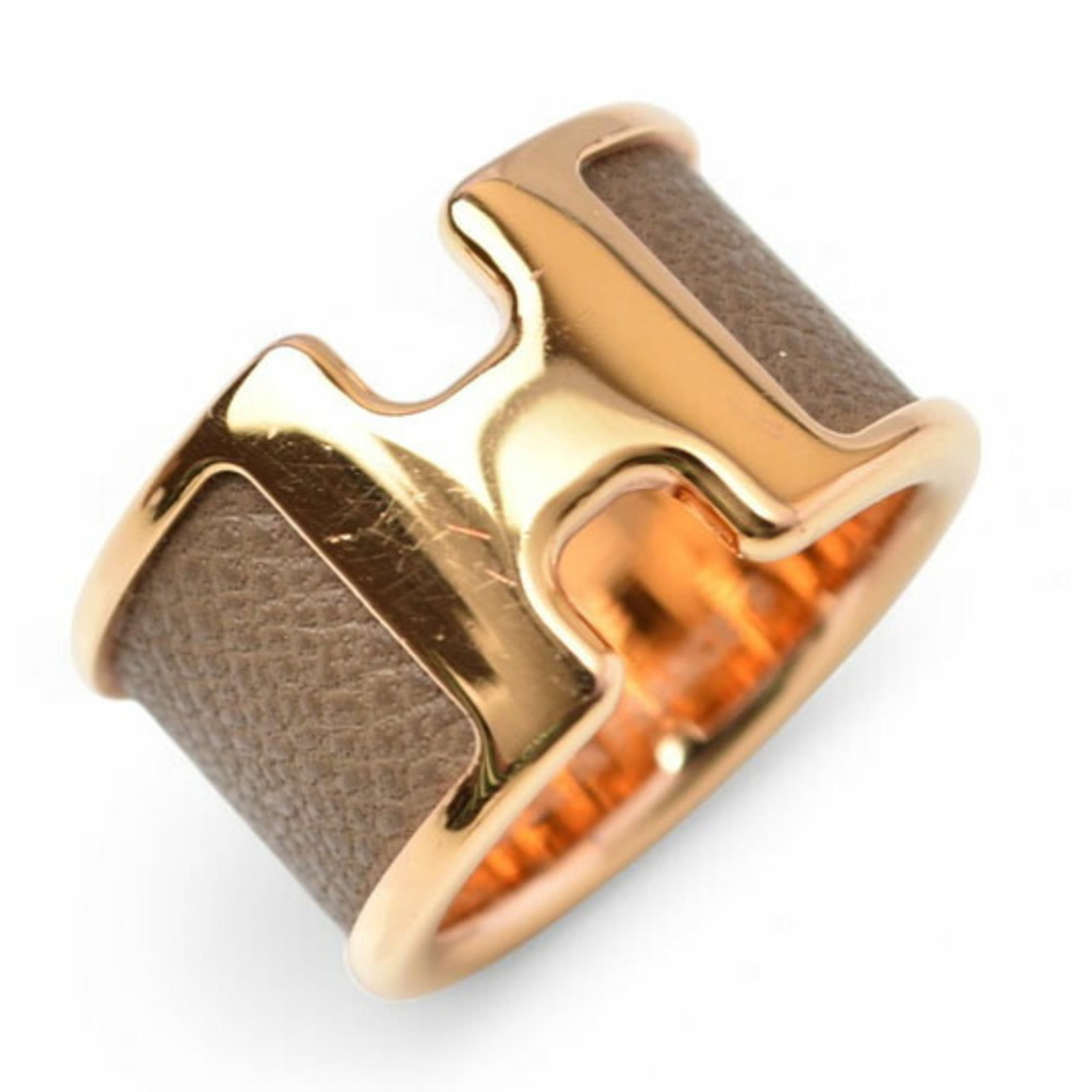 HERMES Band Ring Leather Metal: HERMES Band Ring Leather Metal Etoupe gray and gold meet in perfect harmony on this elegant band ring, crafted from luxurious leather and metal. The subtle sheen of the metal complements the soft,