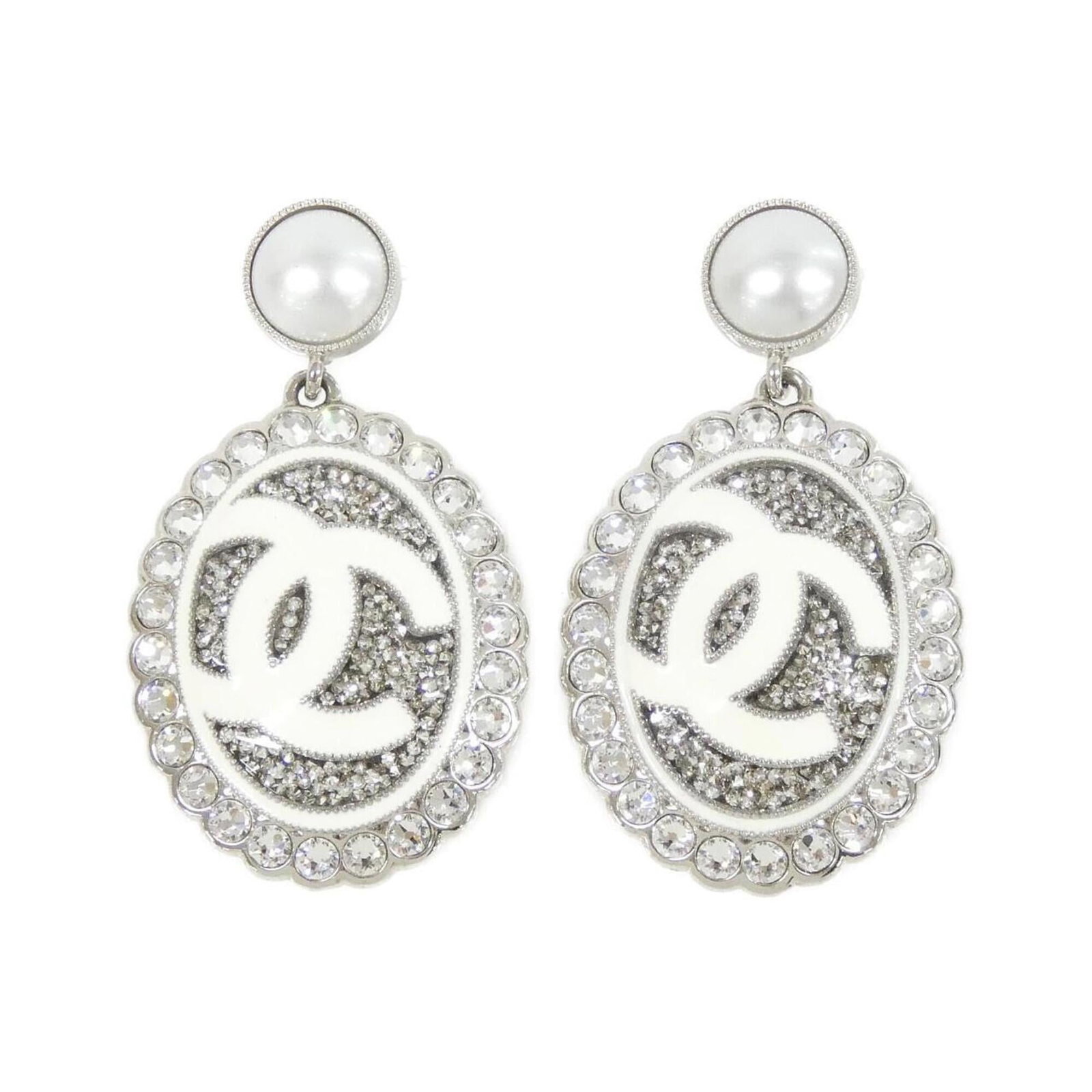 CHANEL Stud Earrings Silver White: CHANEL Stud Earrings Silver White Stud earrings featuring a sleek silver and white design, adorned with crystal stones. Made by the renowned fashion house Chanel, these earrings showcase a sophisticat