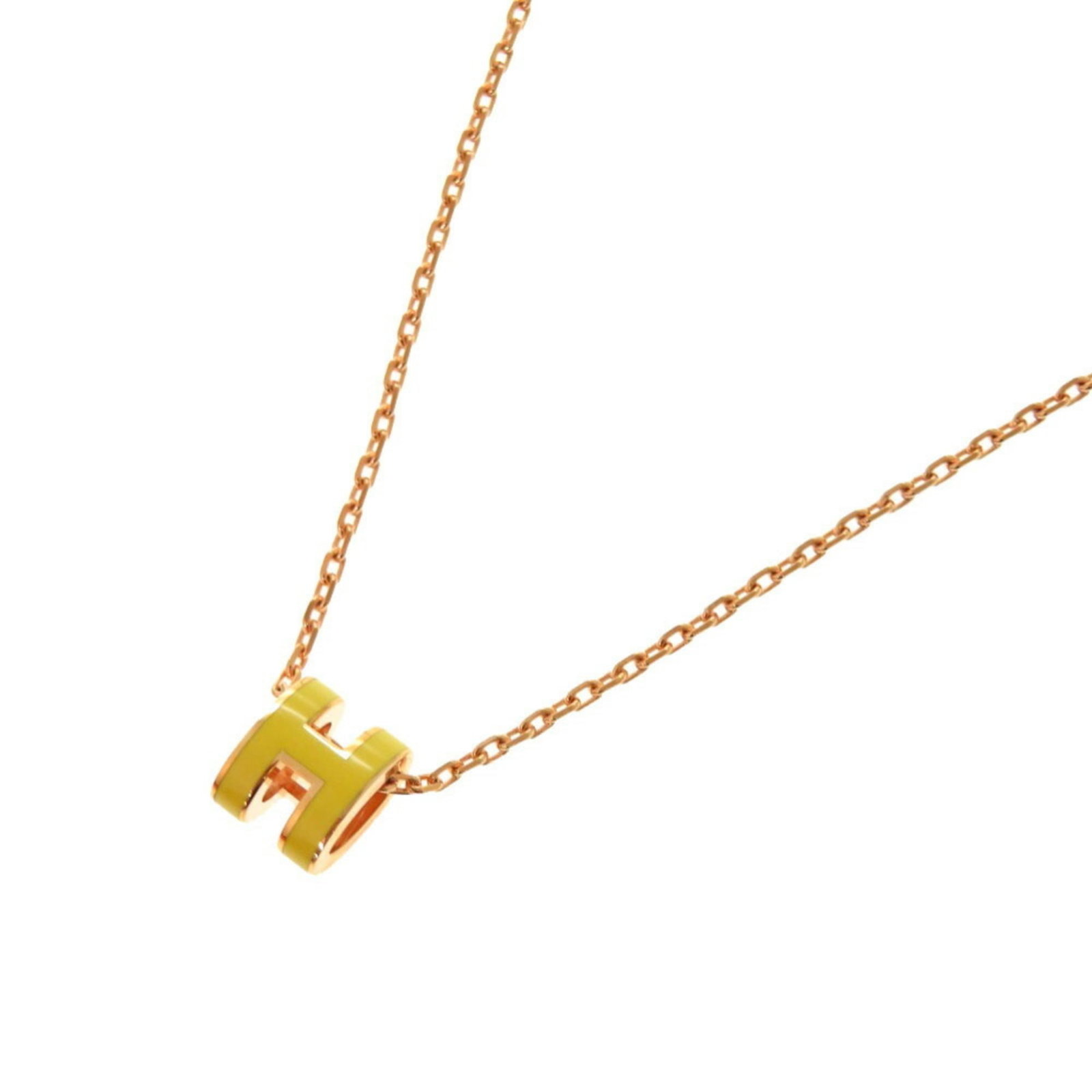 HERMES Metal Yellow: HERMES Metal Yellow Yellow metal necklace with an 8mm x 7mm pendant, presented in a box and dust bag, in like new condition with no visible wear. The necklace features a 40 cm length and a 7mm x 8mm p