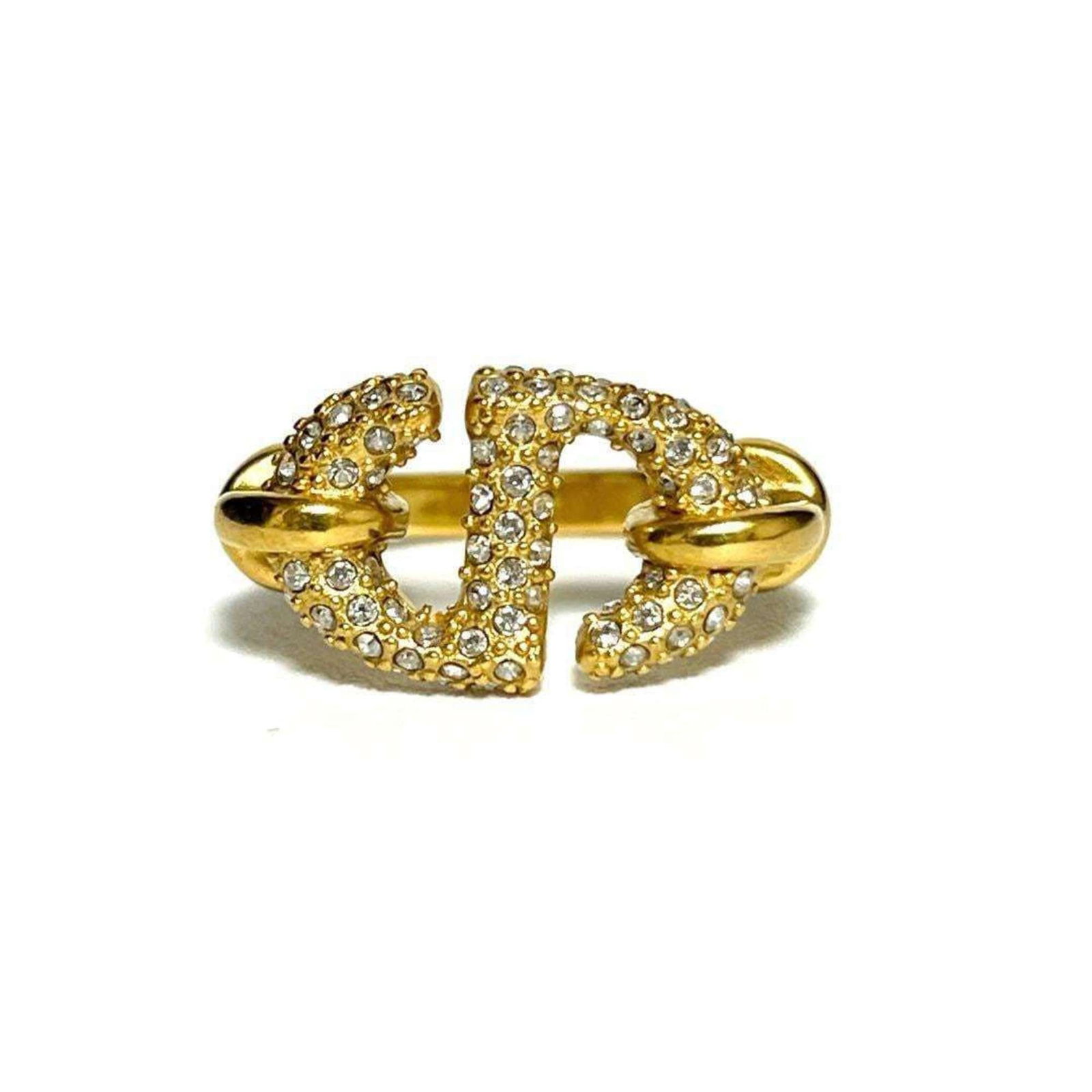 CHRISTIAN DIOR Band Ring Metal Rhinestone: CHRISTIAN DIOR Band Ring Metal Rhinestone Metal band ring from Christian Dior, adorned with rhinestones, adds a touch of luxury to any outfit. The ring's metal construction and rhinestone details