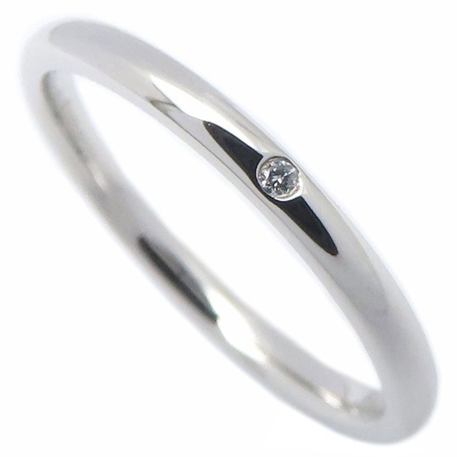 TIFFANY Band Ring Platinum 950: TIFFANY Band Ring Platinum 950 Platinum 950 Tiffany band ring with a diamond stone, available in a US size 6 and 1.9mm width, offering a subtle and elegant accessory for everyday wear. The ring featur