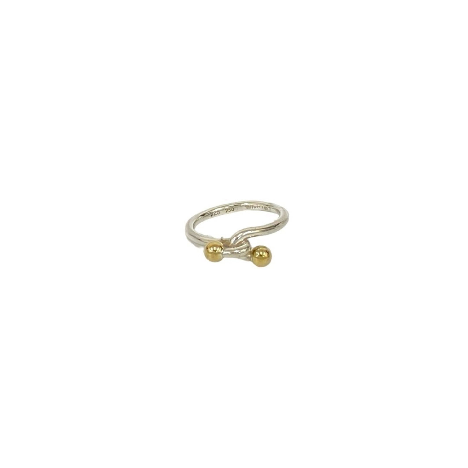 TIFFANY Band Ring Gold (18K) Silver 925: TIFFANY Band Ring Gold (18K) Silver 925 This 18K gold band ring features a classic Tiffany design, crafted with high-quality gold and silver 925. The item is gently used with minor signs of wear, show