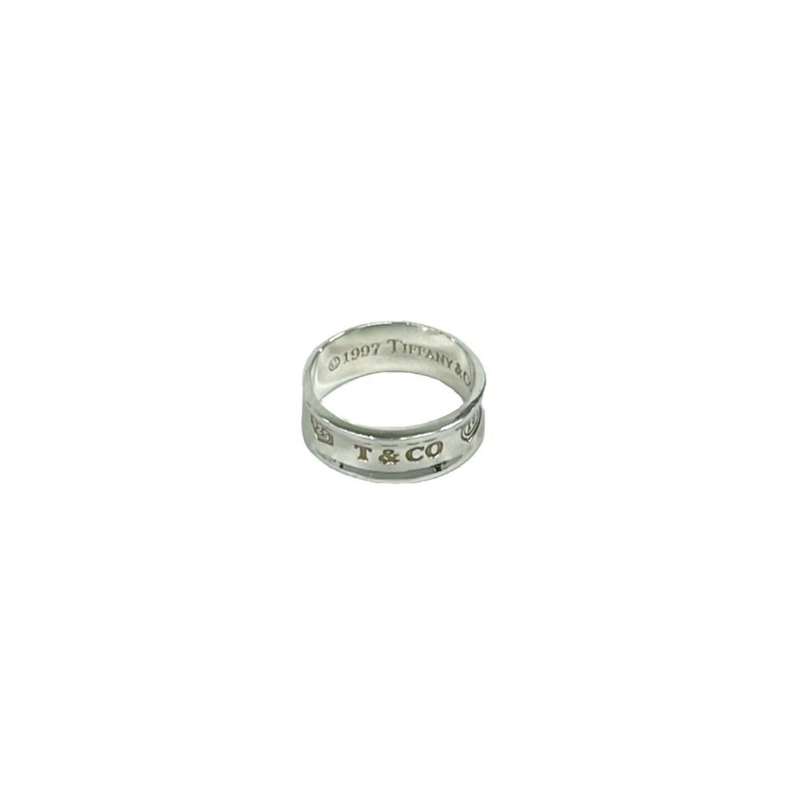 TIFFANY Band Ring Silver 925: TIFFANY Band Ring Silver 925 Silver 925 band ring from Tiffany features a sleek, modern design. The ring bears visible signs of wear, including scratches and scuffs, but remains fully functional. Sold