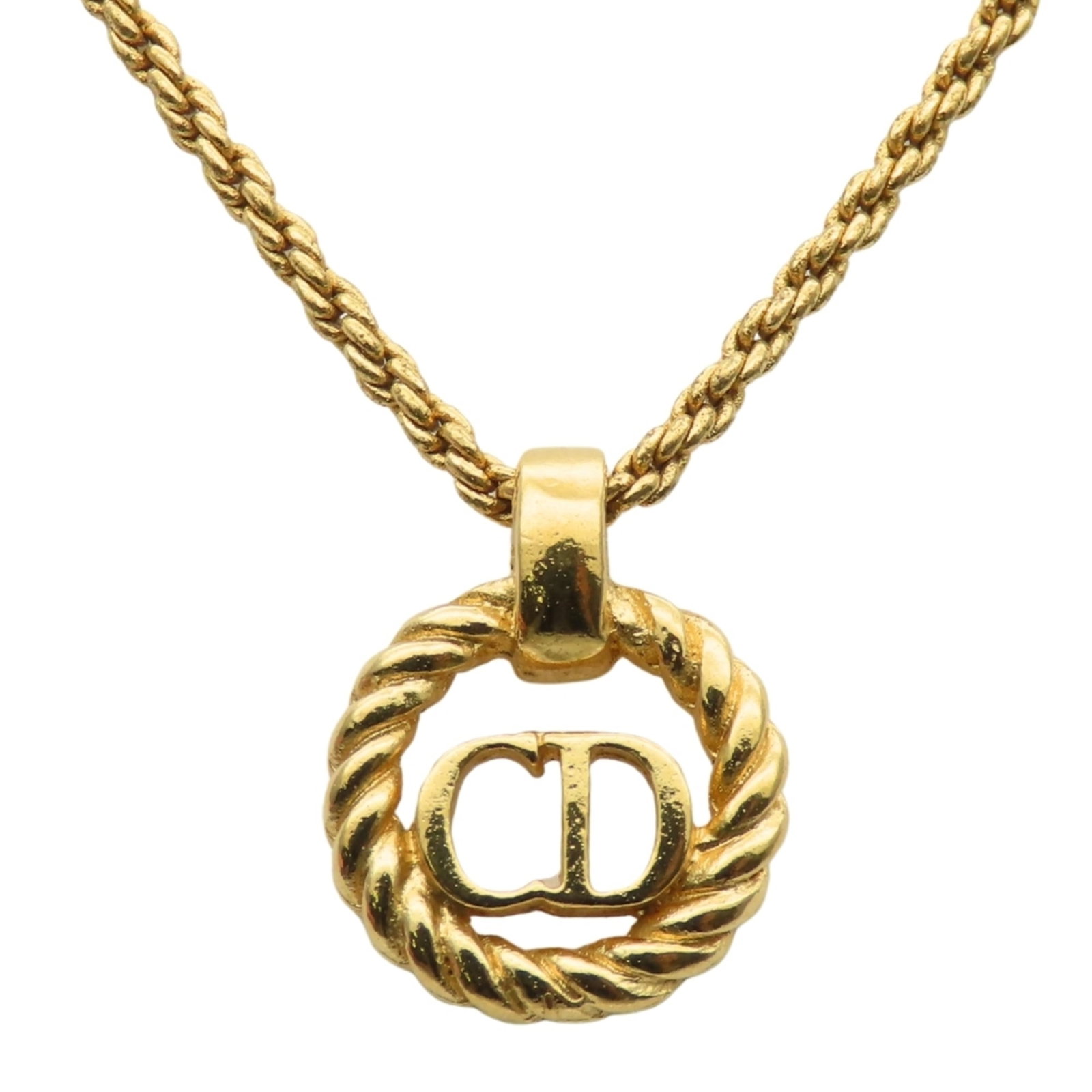 CHRISTIAN DIOR Metal: CHRISTIAN DIOR Metal Gold Metal Christian Dior Necklace with Visible Wear. This 5.3g gold metal necklace features a 15.4mm x 12.5mm pendant and has visible scratches, scuffs, and dirt. The item is in