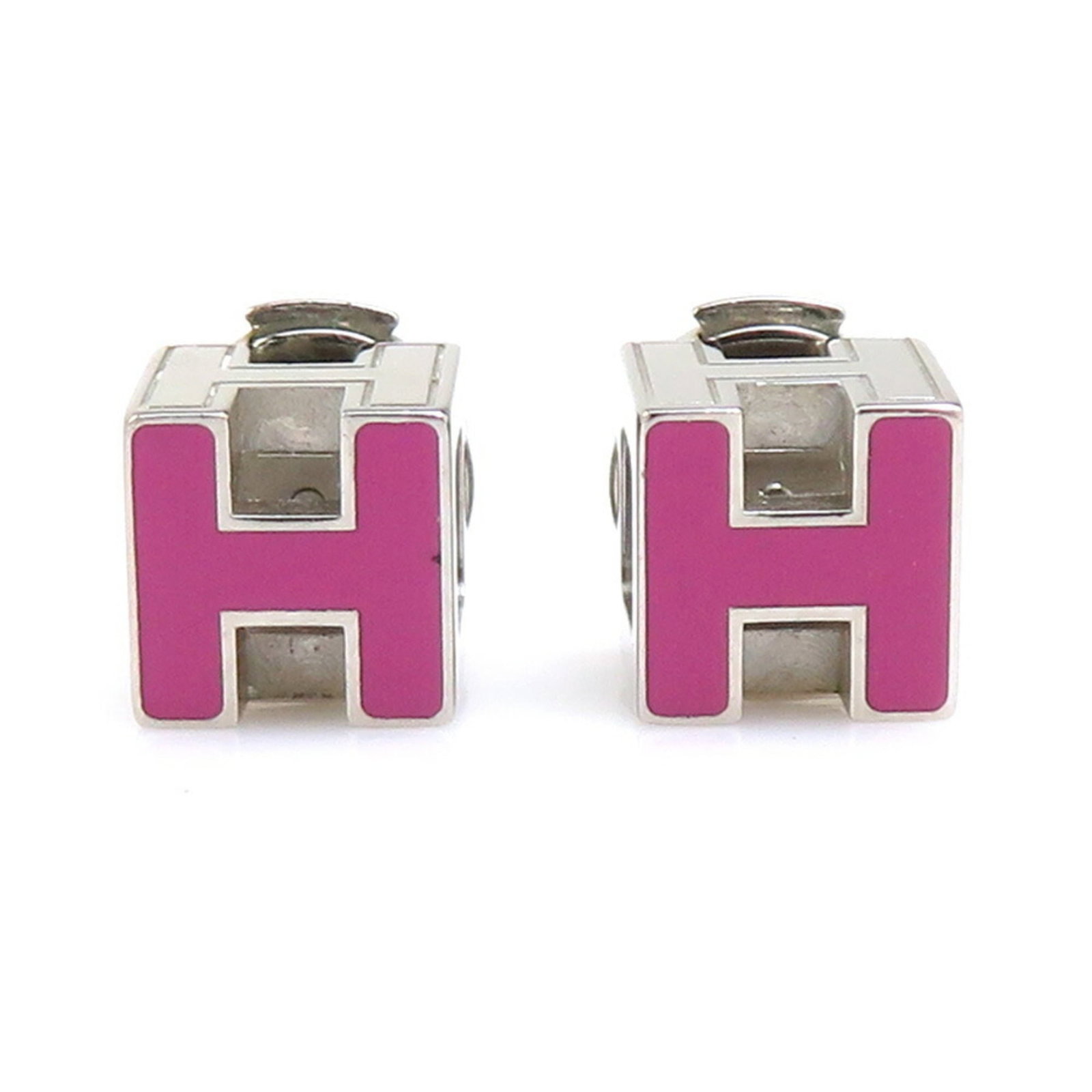 HERMES Stud Earrings Enamel Metal: HERMES Stud Earrings Enamel Metal Magenta enamel and silver metal stud earrings from Hermes, bearing visible scratches and scuffs, are available in good used condition. These earrings measure 7.00mm