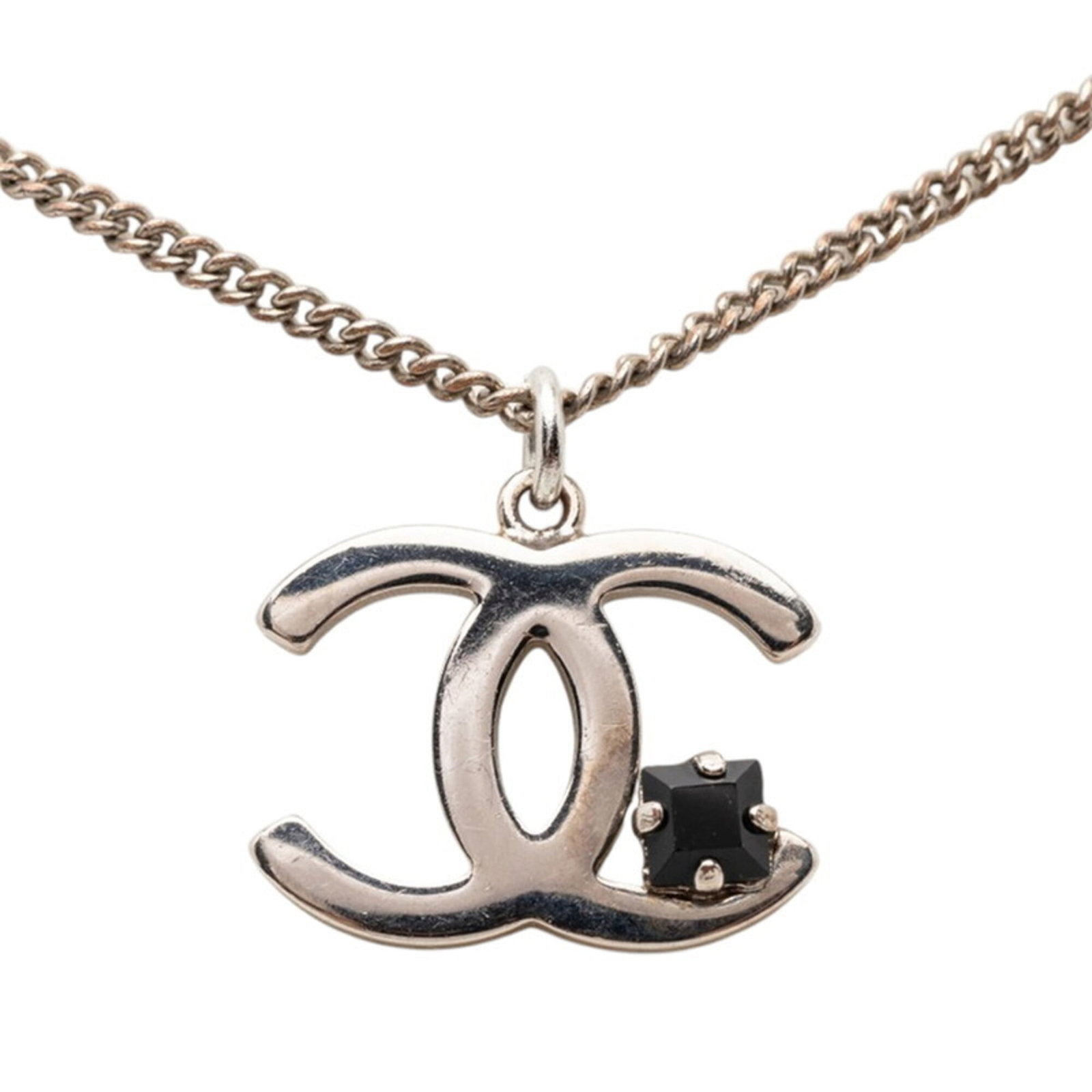 CHANEL Metal Black Silver: CHANEL Metal Black Silver The CHANEL Metal Black Silver necklace boasts a sleek, modern design with a 15mm x 19mm pendant in a striking black and silver finish. This statement piece features a metal c