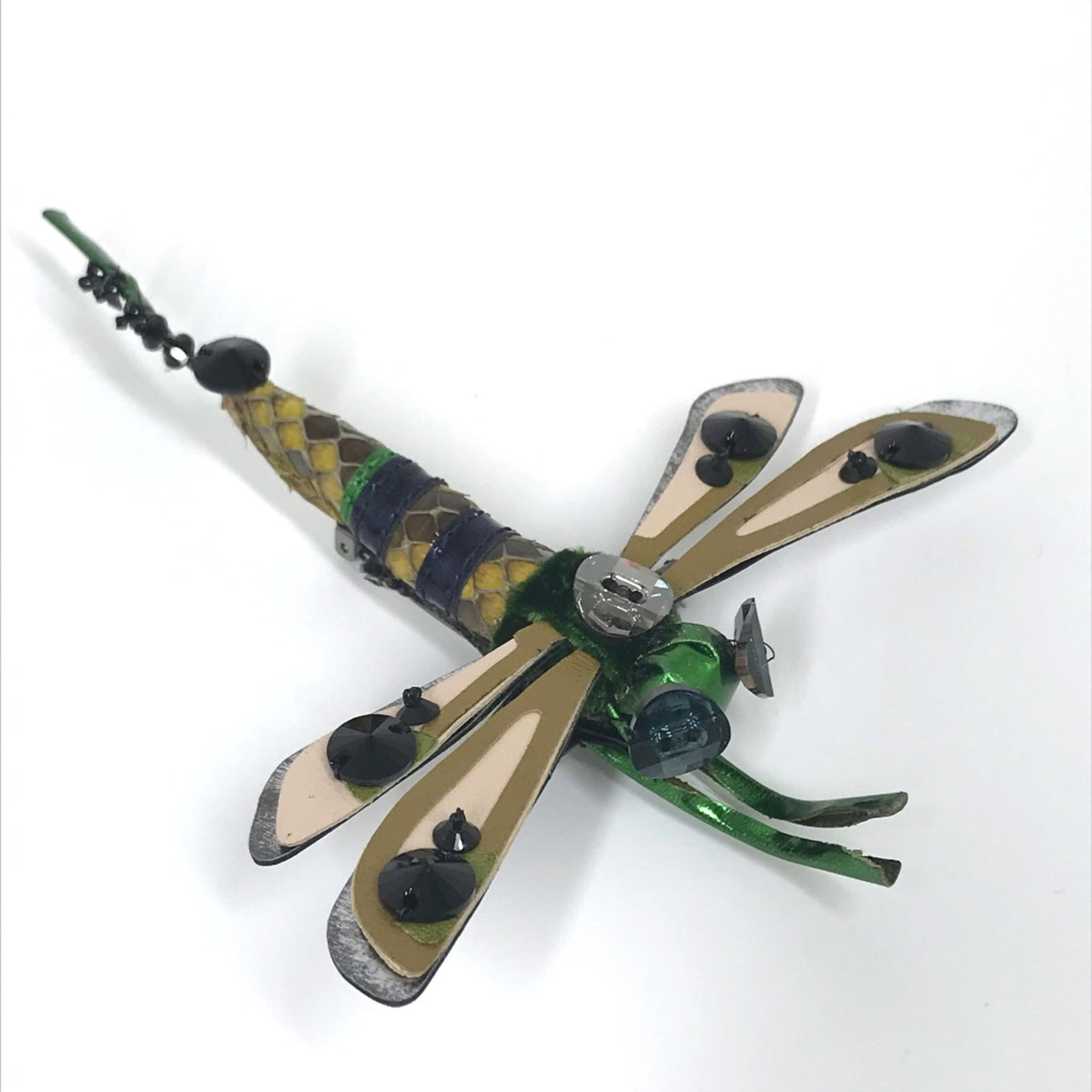 MIU MIU Brooch Leather: MIU MIU Brooch Leather The Miu Miu Brooch Leather is a stylish accessory featuring genuine leather construction. It boasts a distinctive design with a signature that bears a mark of the brand's