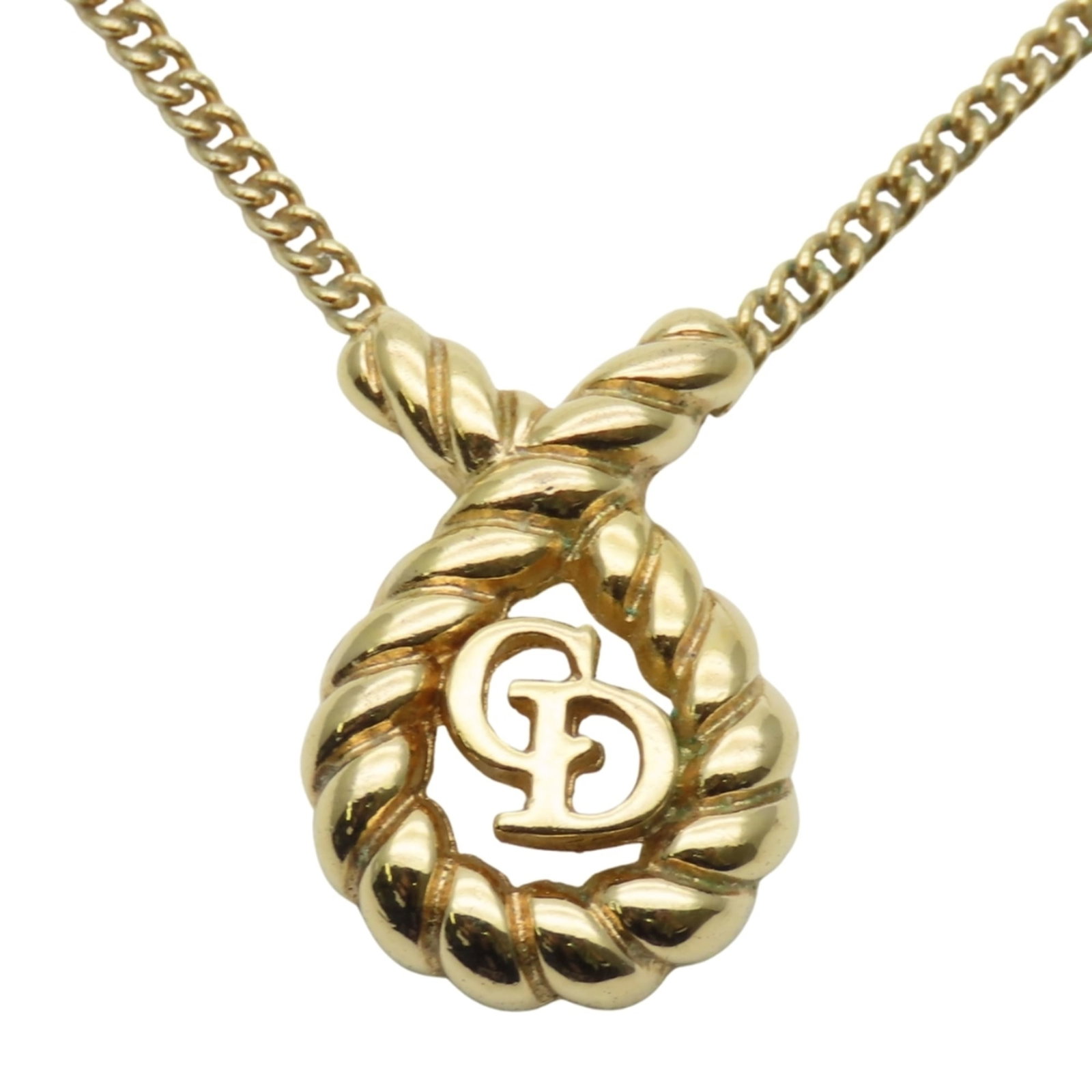CHRISTIAN DIOR Metal: CHRISTIAN DIOR Metal Gold Christian Dior Metal Necklace with Visible Wear. This 42.5 cm gold necklace features a 18.7mm x 13mm metal pendant and weighs 5.9g. The necklace is in good used condition