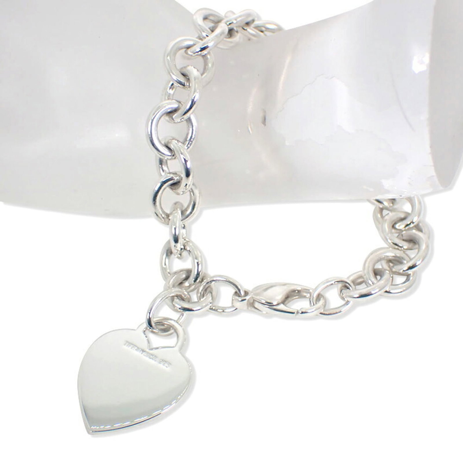 TIFFANY Charm Bracelet Sterling Silver 925: TIFFANY Charm Bracelet Sterling Silver 925 Sterling silver 925 Tiffany charm bracelet in excellent condition, measuring 19cm in length. This like new used bracelet boasts a delicate charm design, show