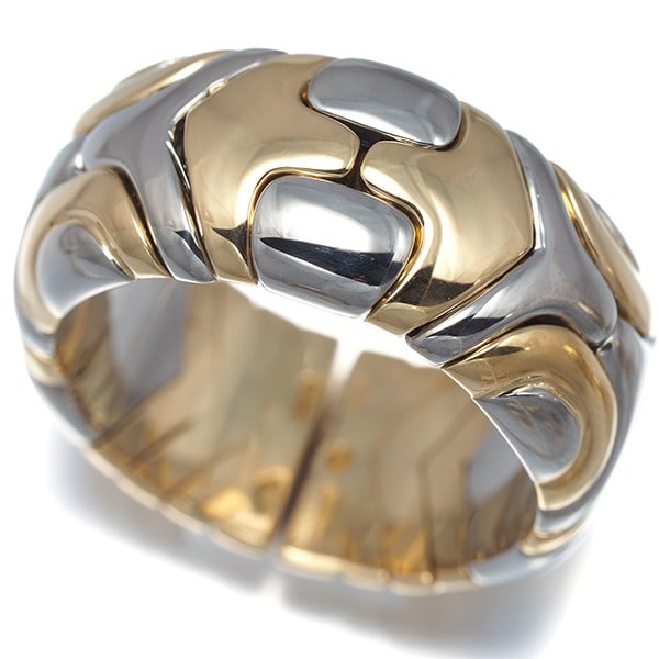 Bvlgari Ring Alveare Us7 18K 750 Yellow Gold/Stainless Steel: Bvlgari Ring Alveare Us7 18K 750 Yellow Gold/Stainless Steel The Bvlgari Alveare Us7 ring boasts a striking 18k yellow gold and stainless steel design, with a 10.0mm wide band that adds a touch of sop