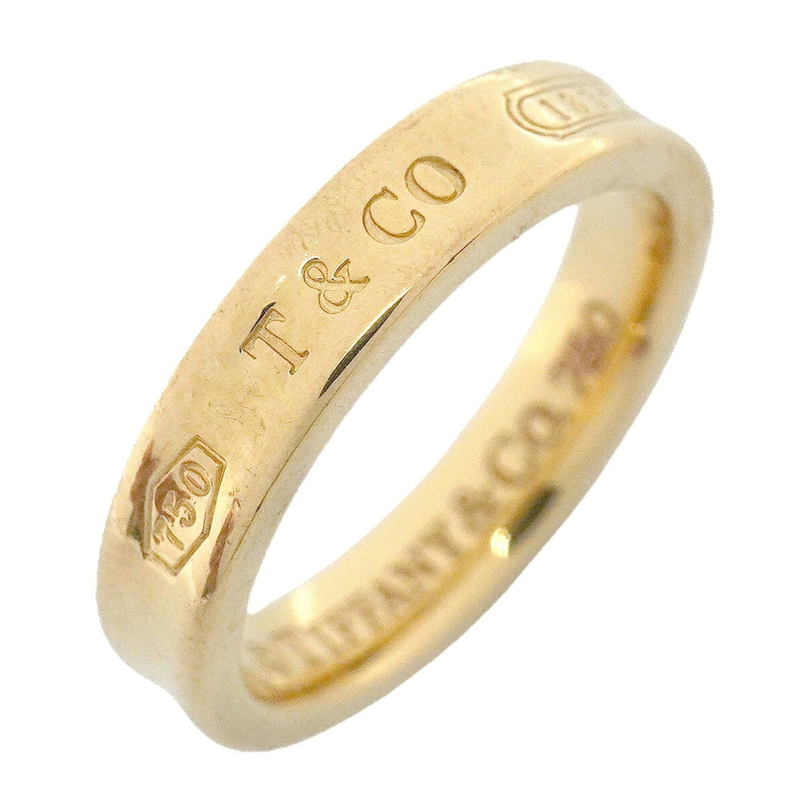 TIFFANY Band Ring Yellow Gold (18K): TIFFANY Band Ring Yellow Gold (18K) Yellow gold 18K band ring from Tiffany, featuring a classic design with visible wear and scratches, a testament to its well-loved status. This pre-owned ring is in